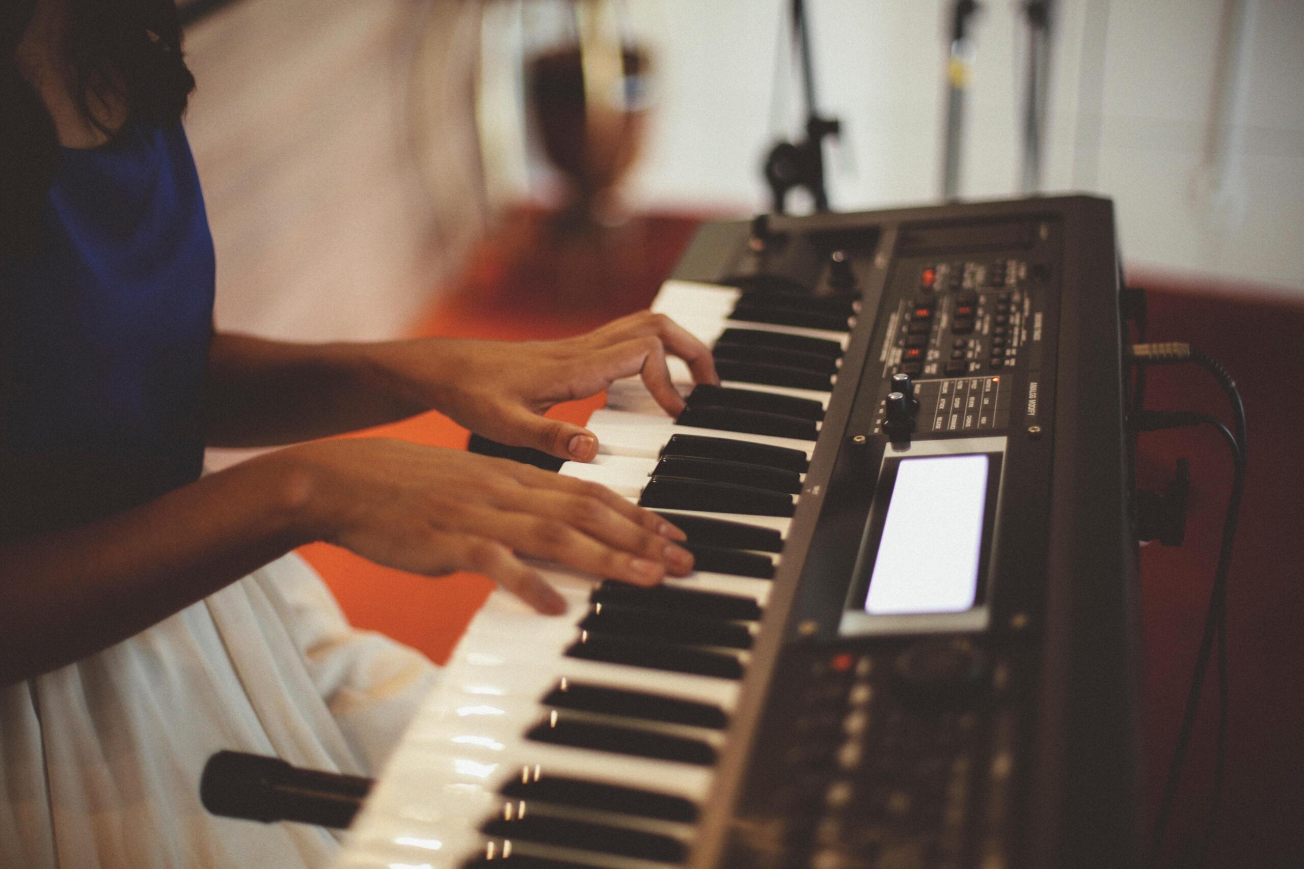 woman playing on a keyboard piano