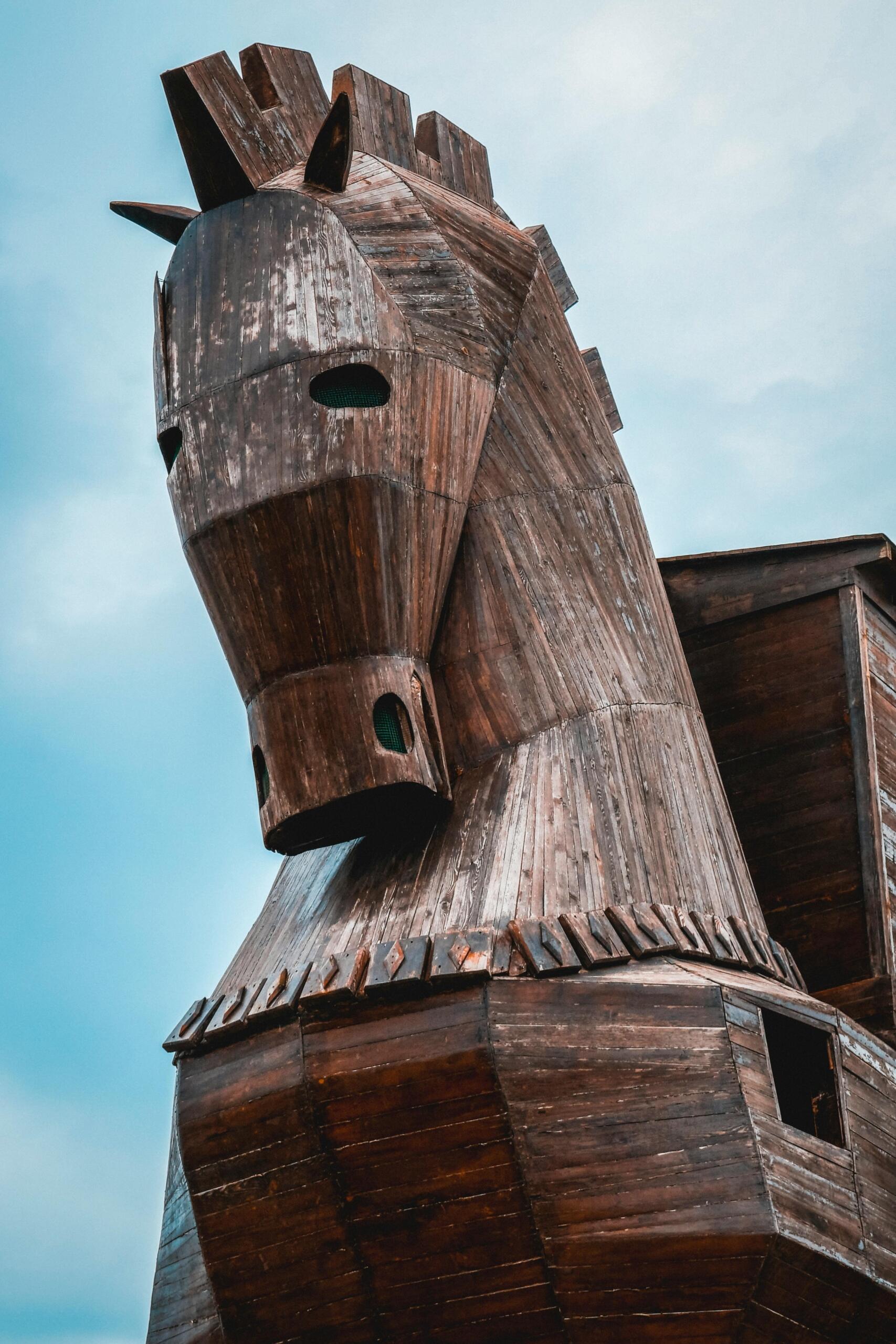 Large wooden replica of the Trojan Horse on display, featuring a detailed structure with a hollow interior and staircase access.