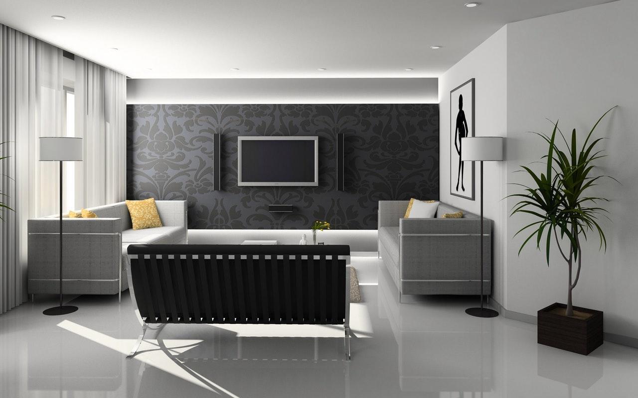 interior of a living room with a television and several sofas