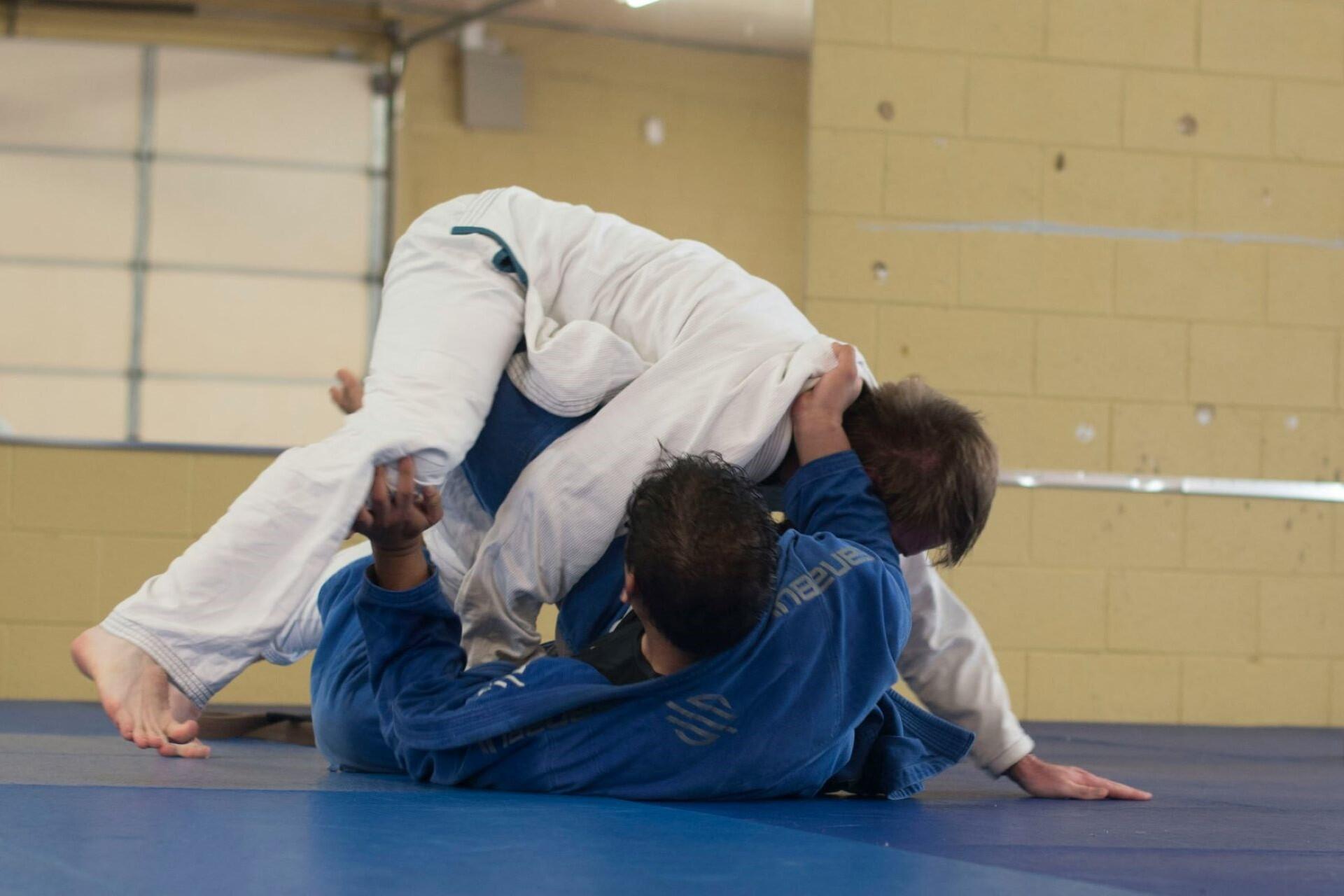 Two people sparring in judo.