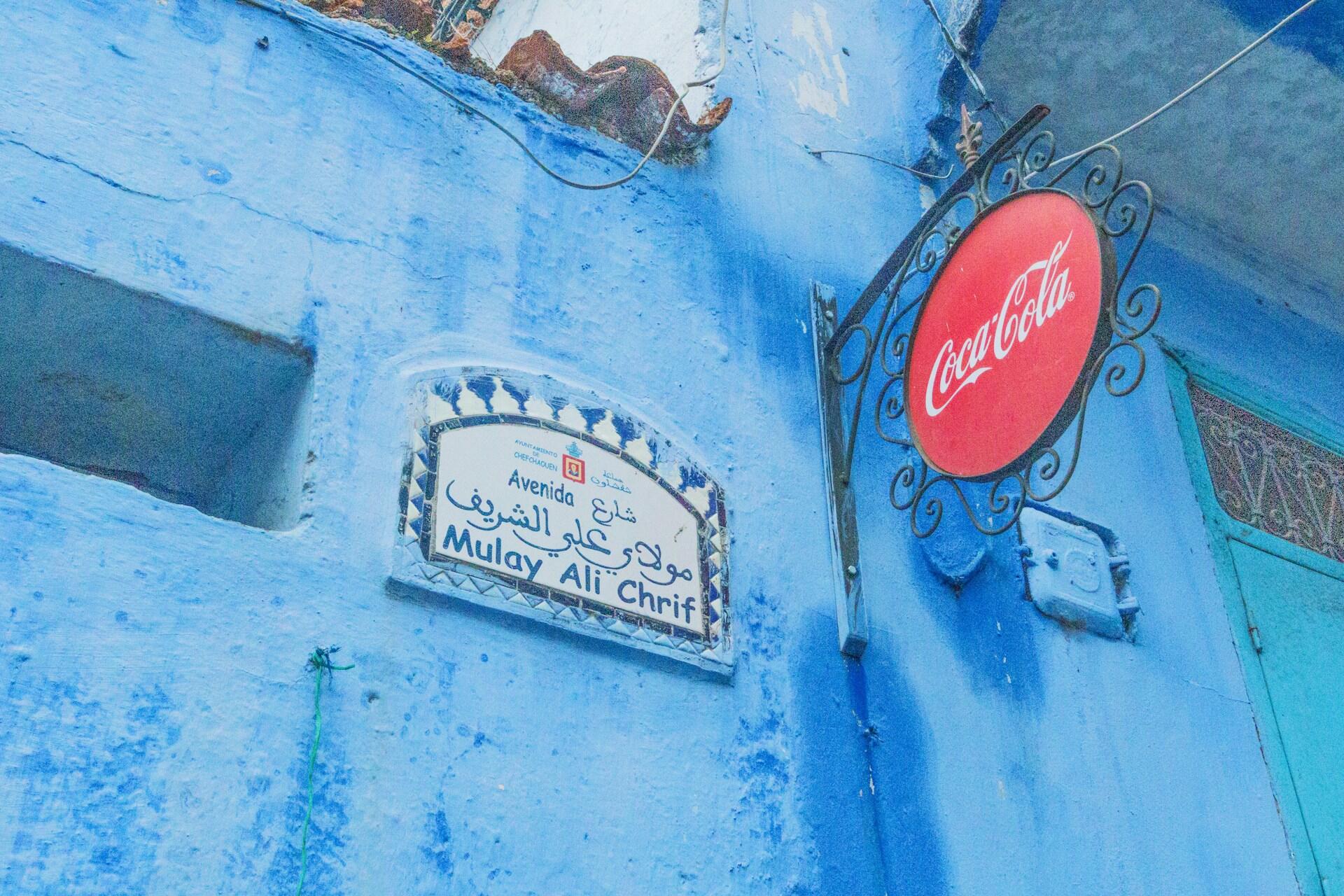 Blue wall with a street sign reading