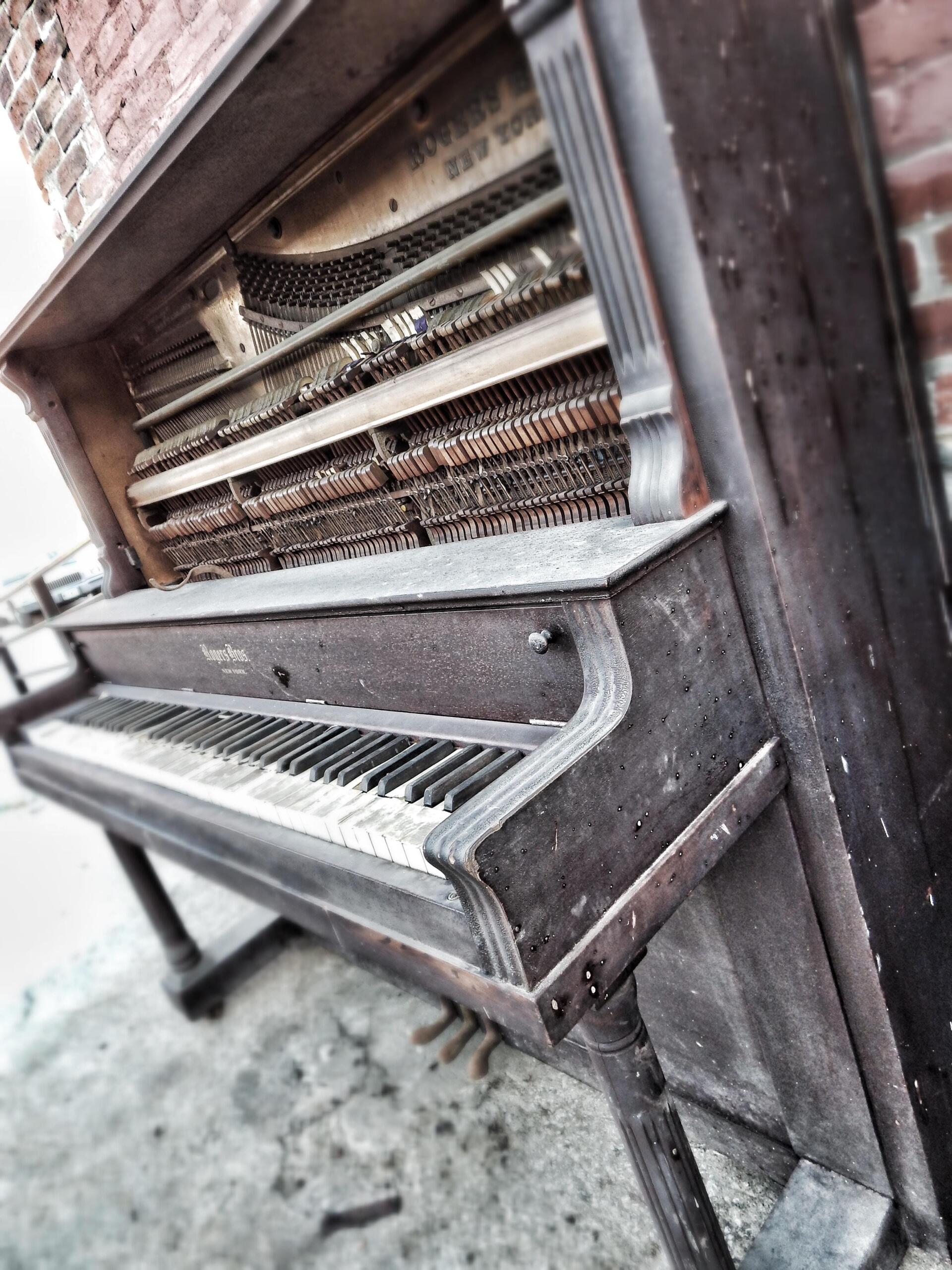 an old piano with broken keys