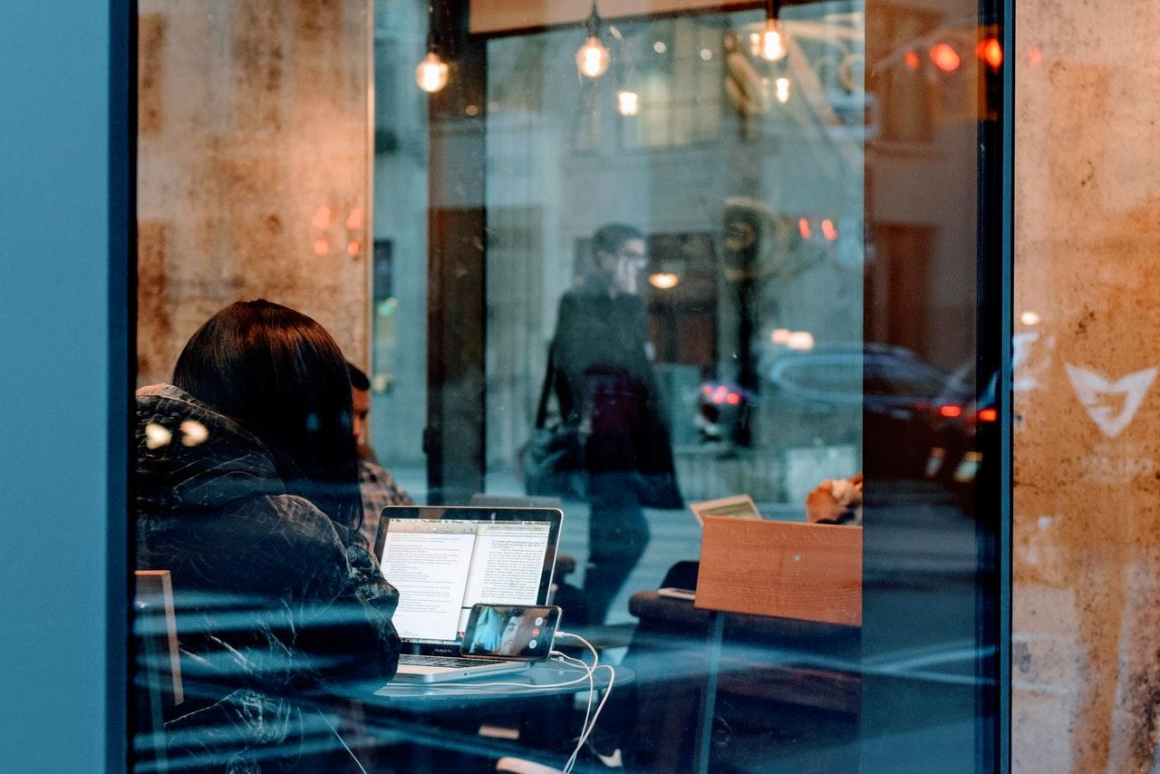 a group of people seated at a desk working in front of a computer