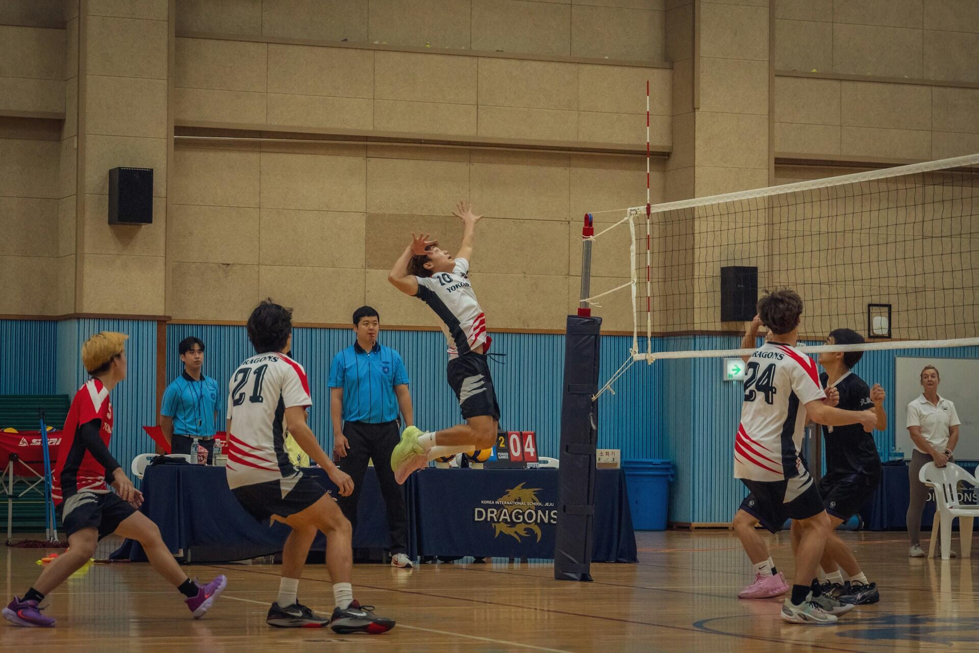 A volleyball team in the middle of a game.