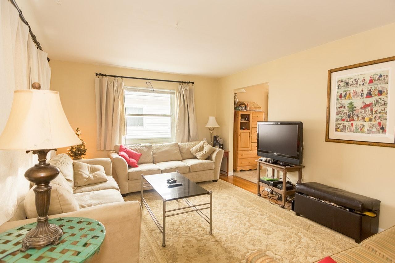 a traditional living room with a television and several sofas