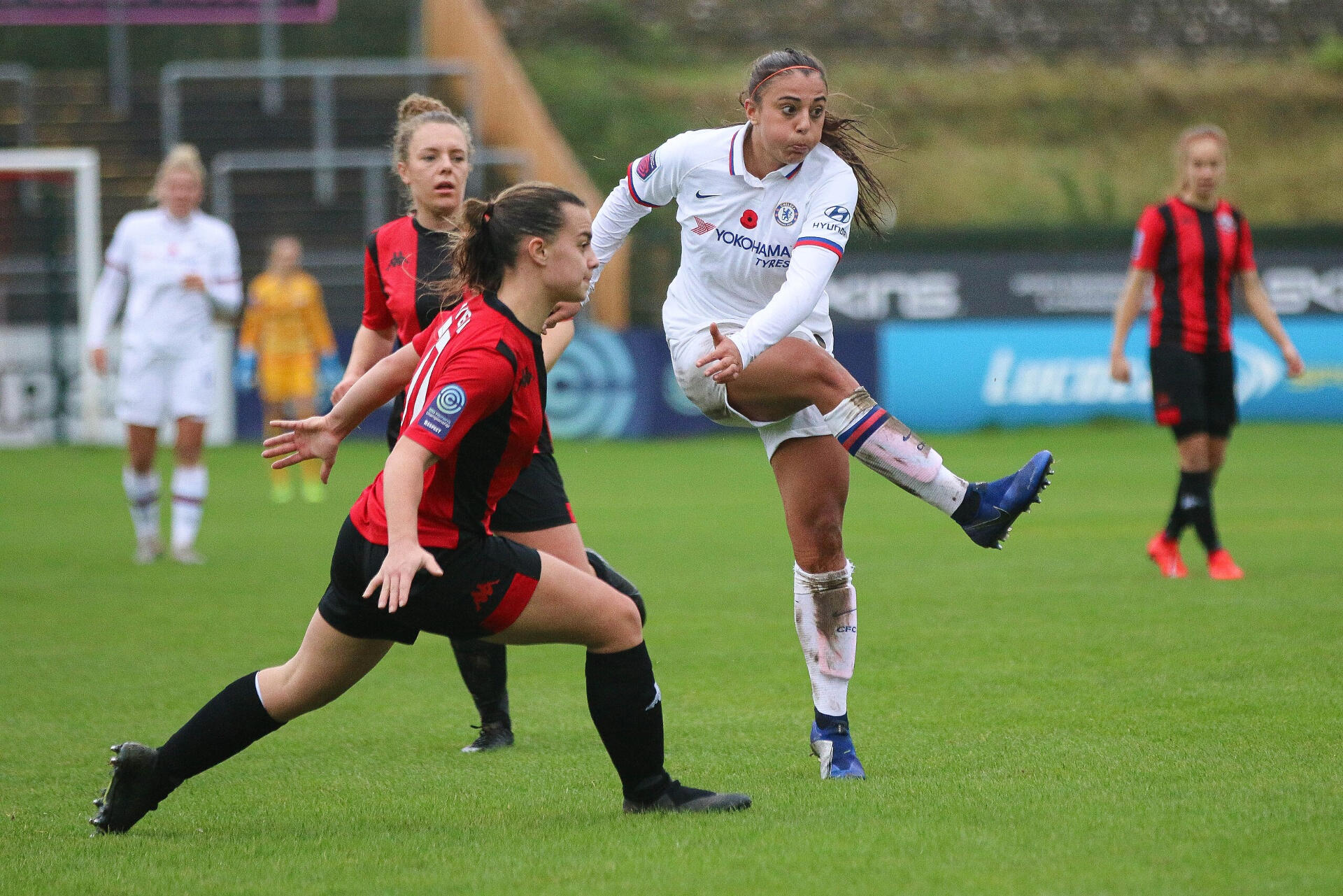 Two women football players on a pitch