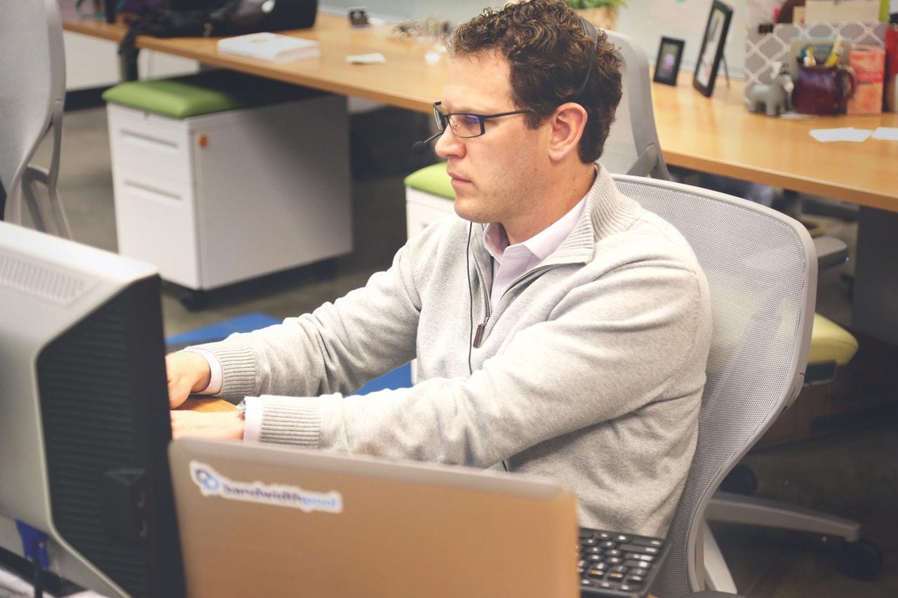 man working at a desk in an office