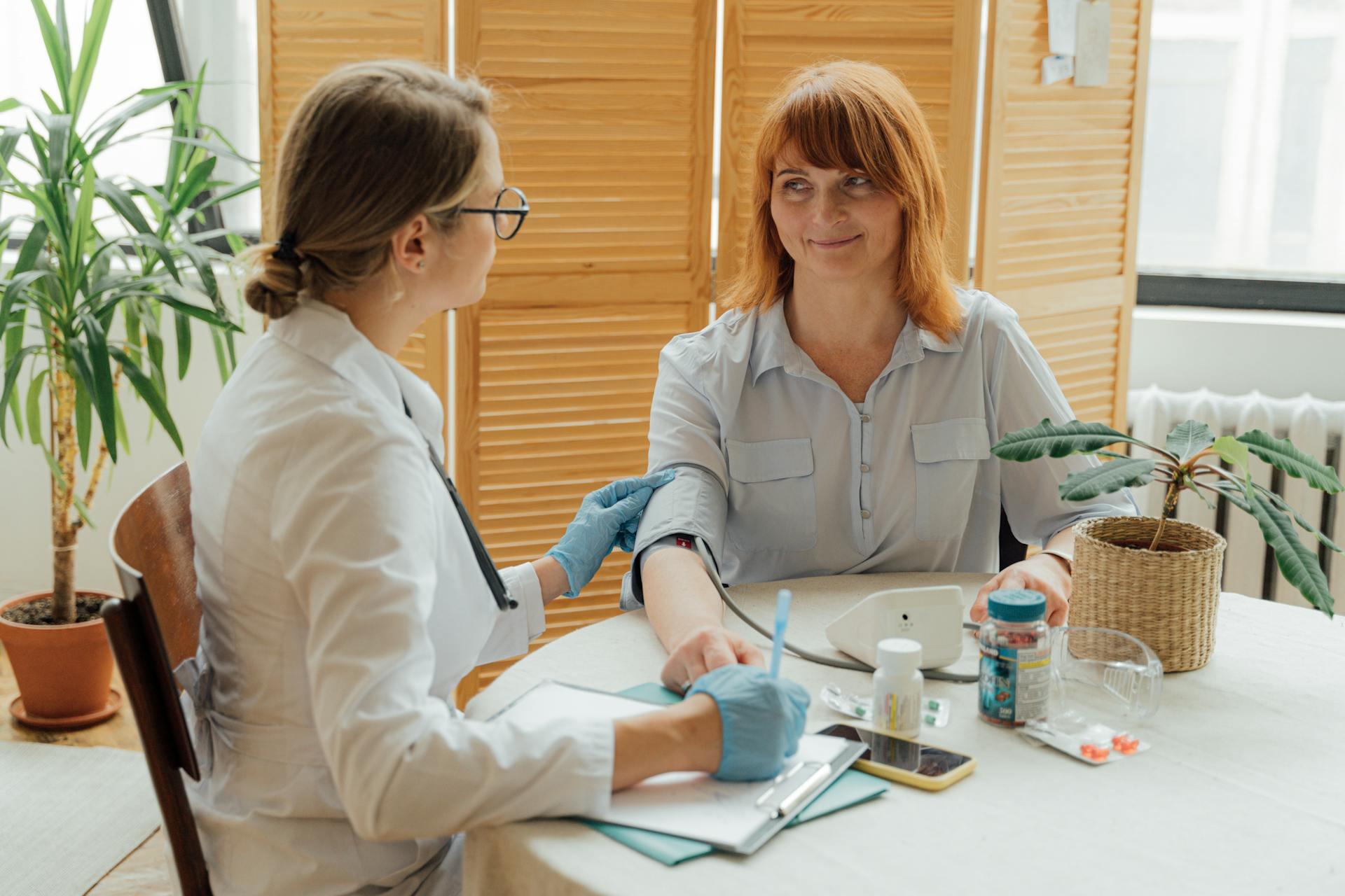 Image of a nurse taking woman's blood pressure