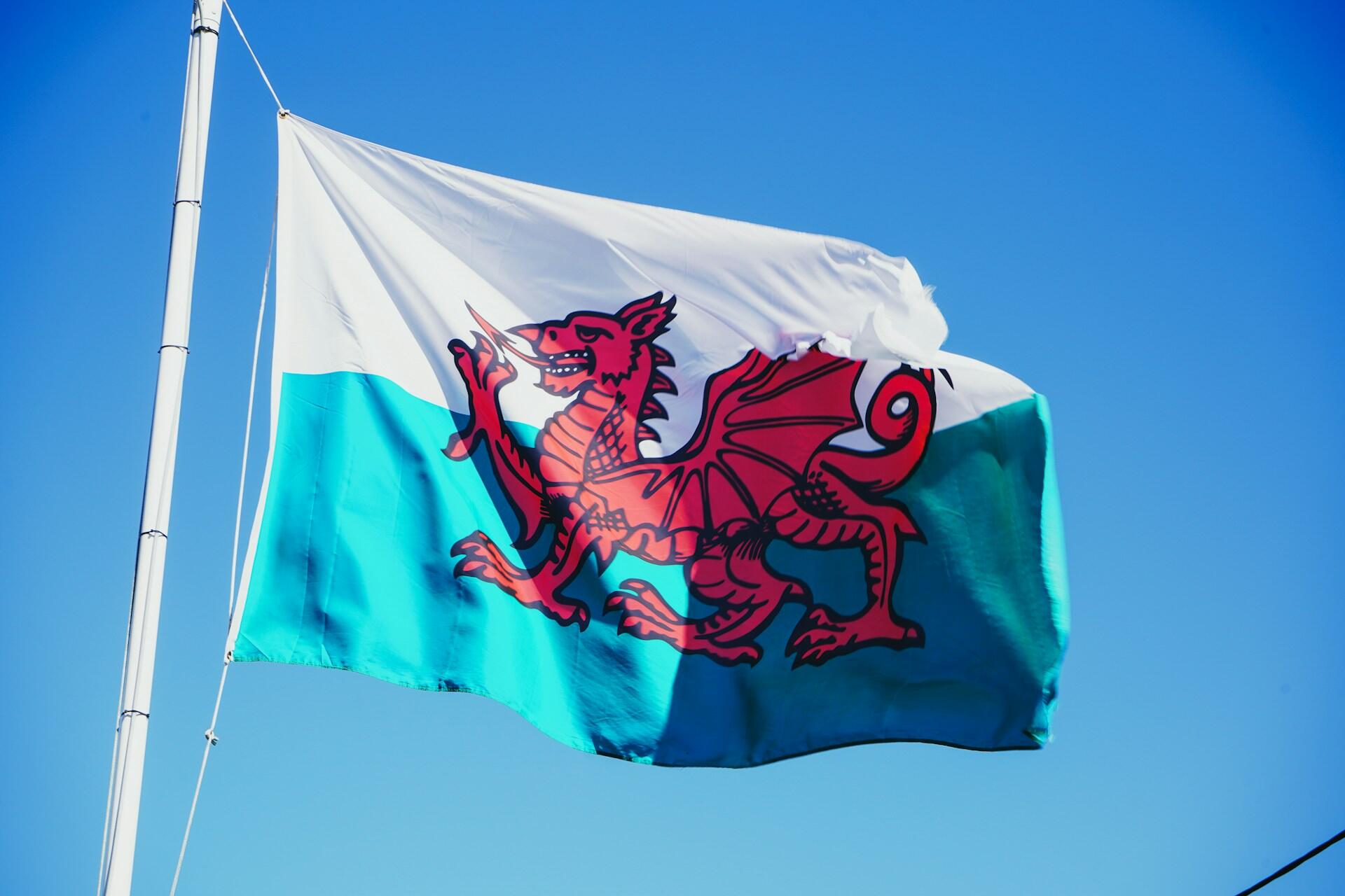 The Welsh flag against a blue sky.