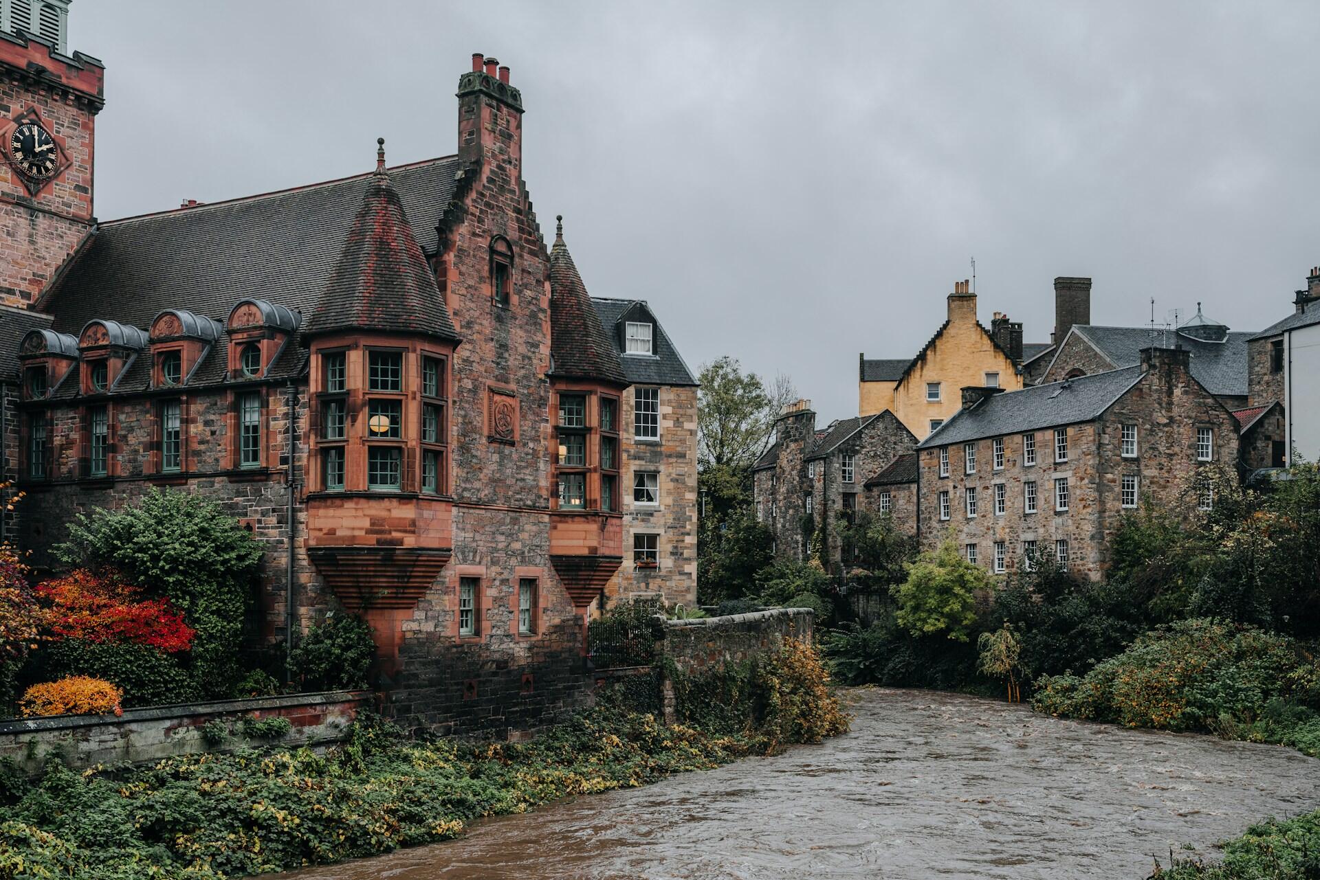 Stone houses alongside a narrow river.