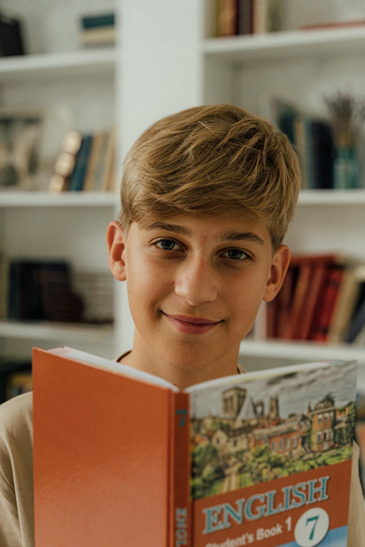 A child reads an English textbook in a cozy room filled with bookshelves, showcasing a warm and inviting study environment.
