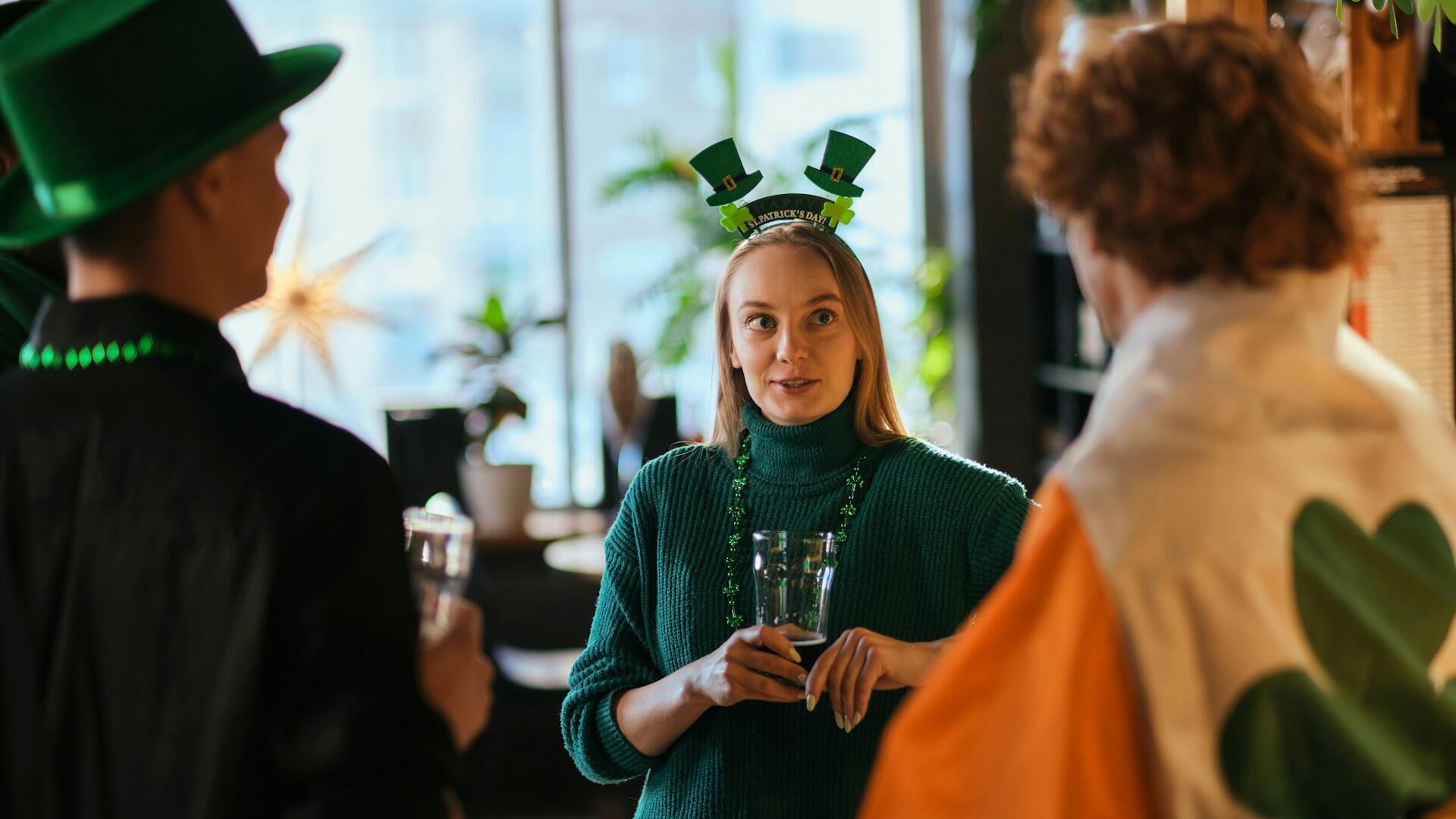 Three people wearing St Paddy's Day regalia.