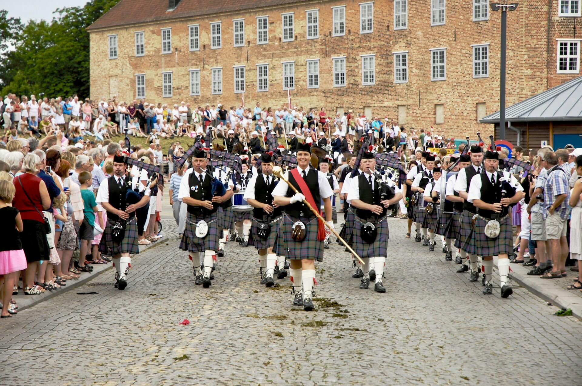 A parade of men wearing kilts.