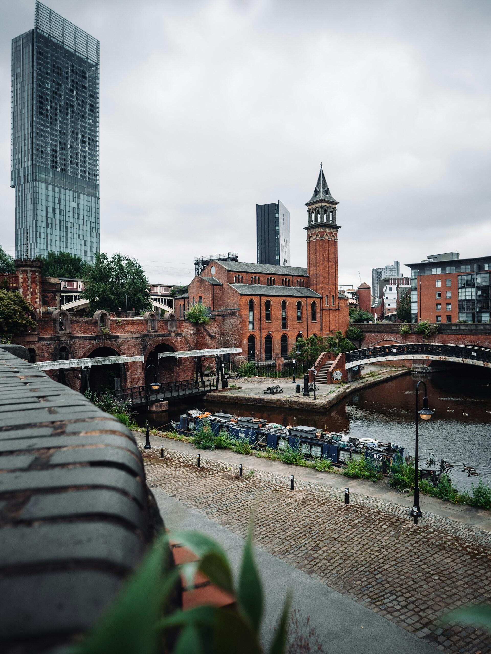 A waterway surrounded with brick buildings.