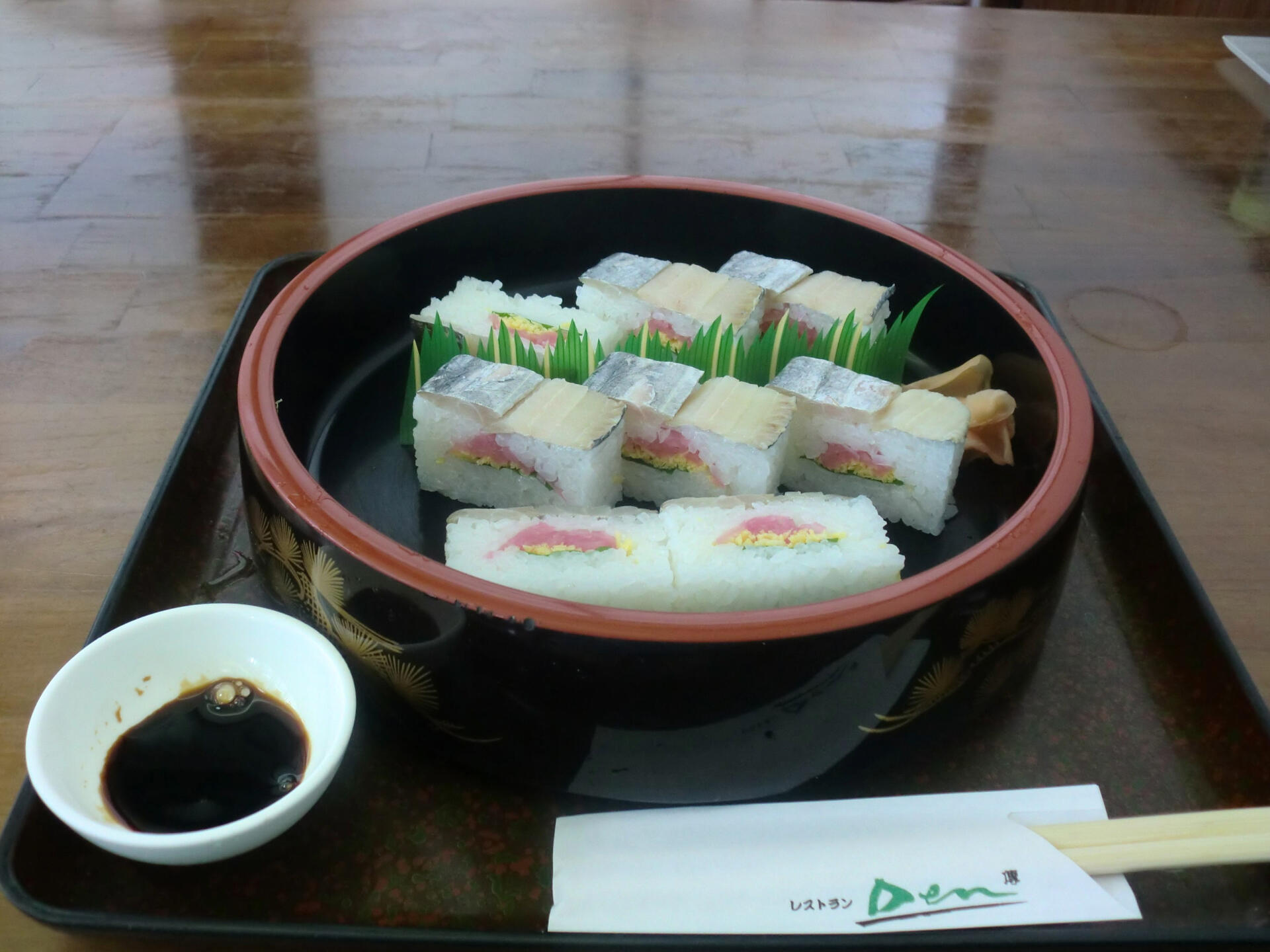 Image of oshizushi on a tray with soy sauce 