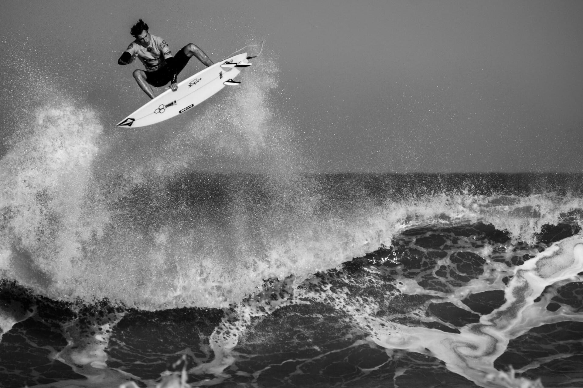 A surfer jumping off a wave.