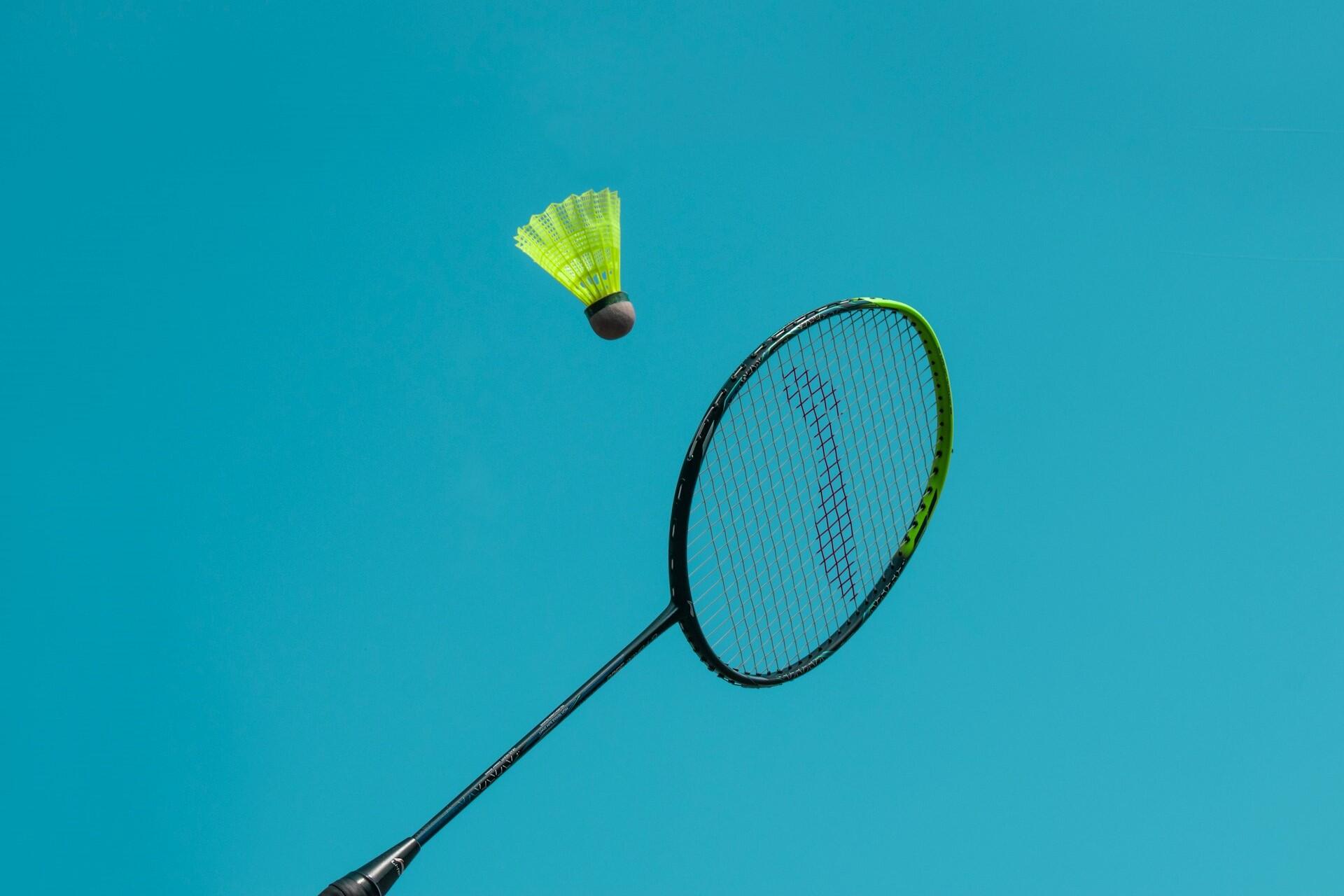 A badminton racquet receiving a shot.
