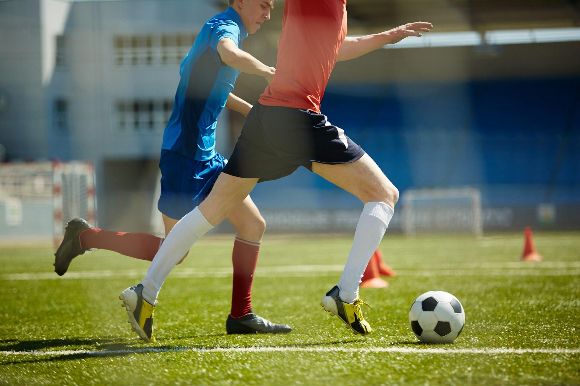 two people playing football on a field