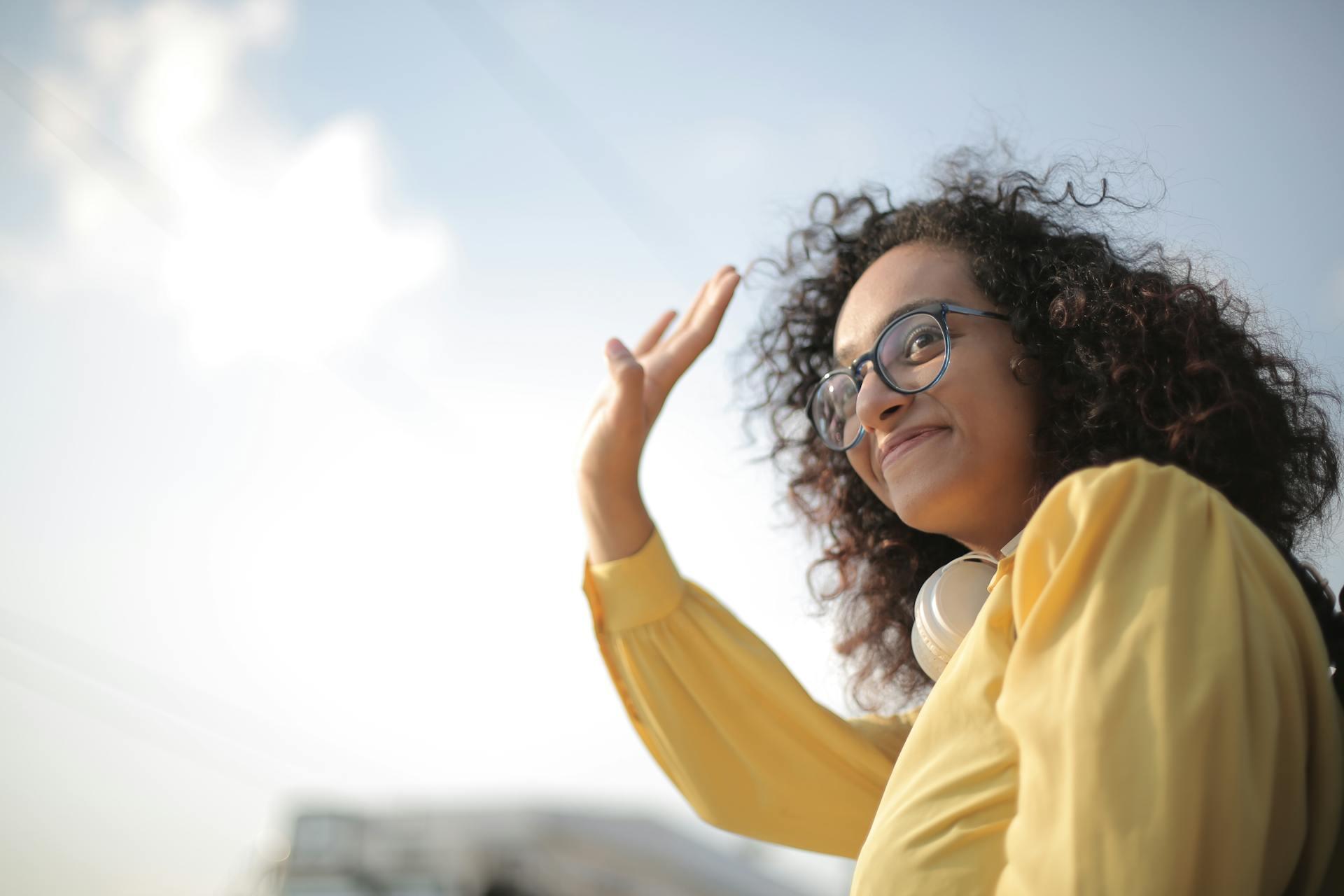 Lady in yellow outfit waving goodbye
