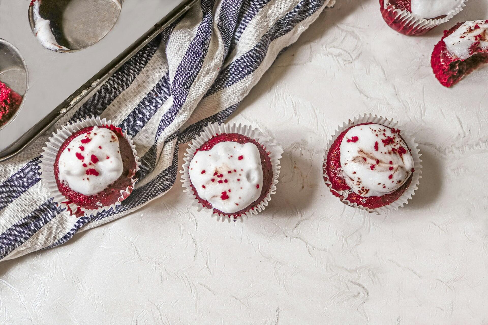 Three red velvet cupcakes.