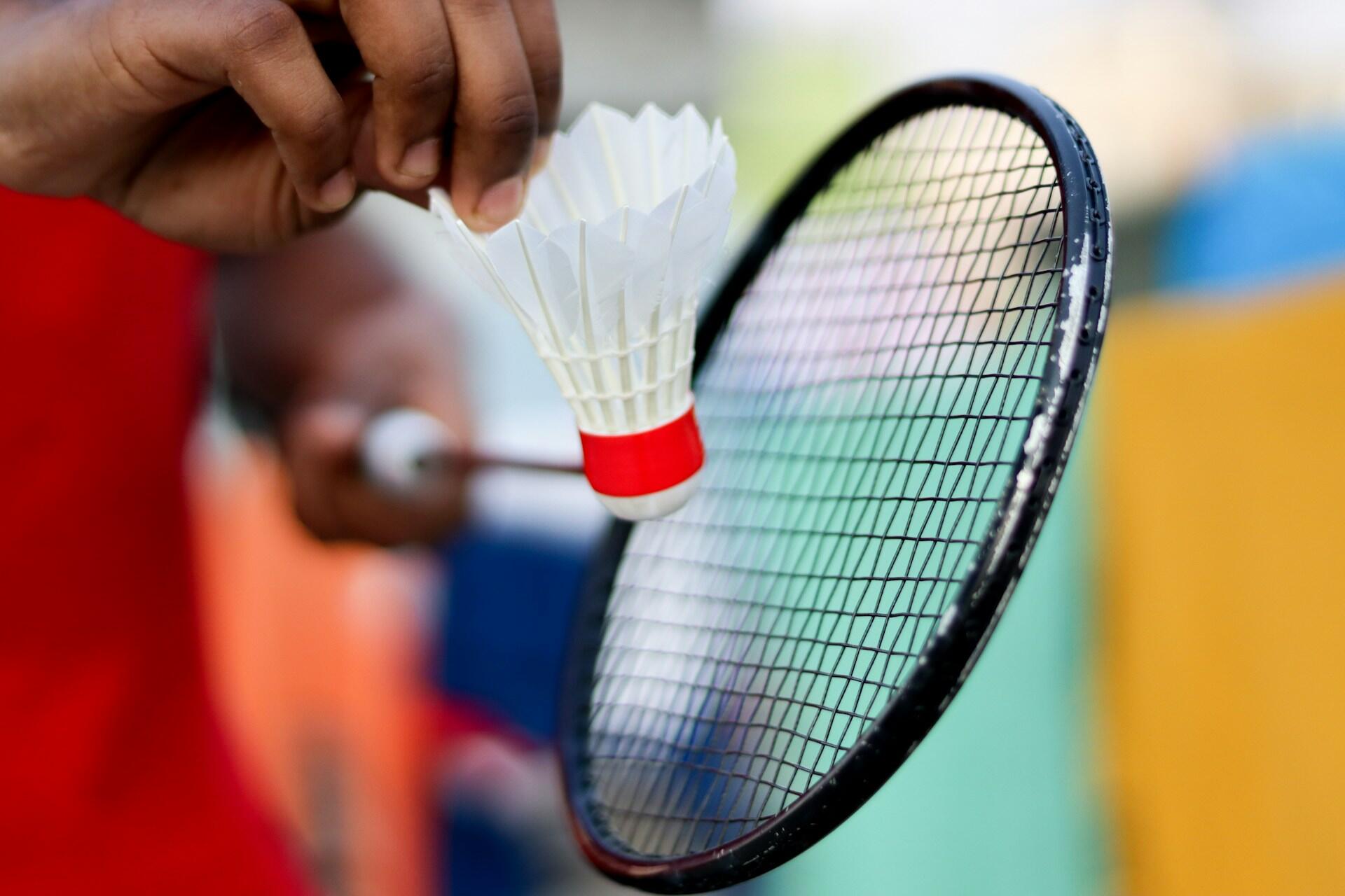 A badminton player ready to serve.
