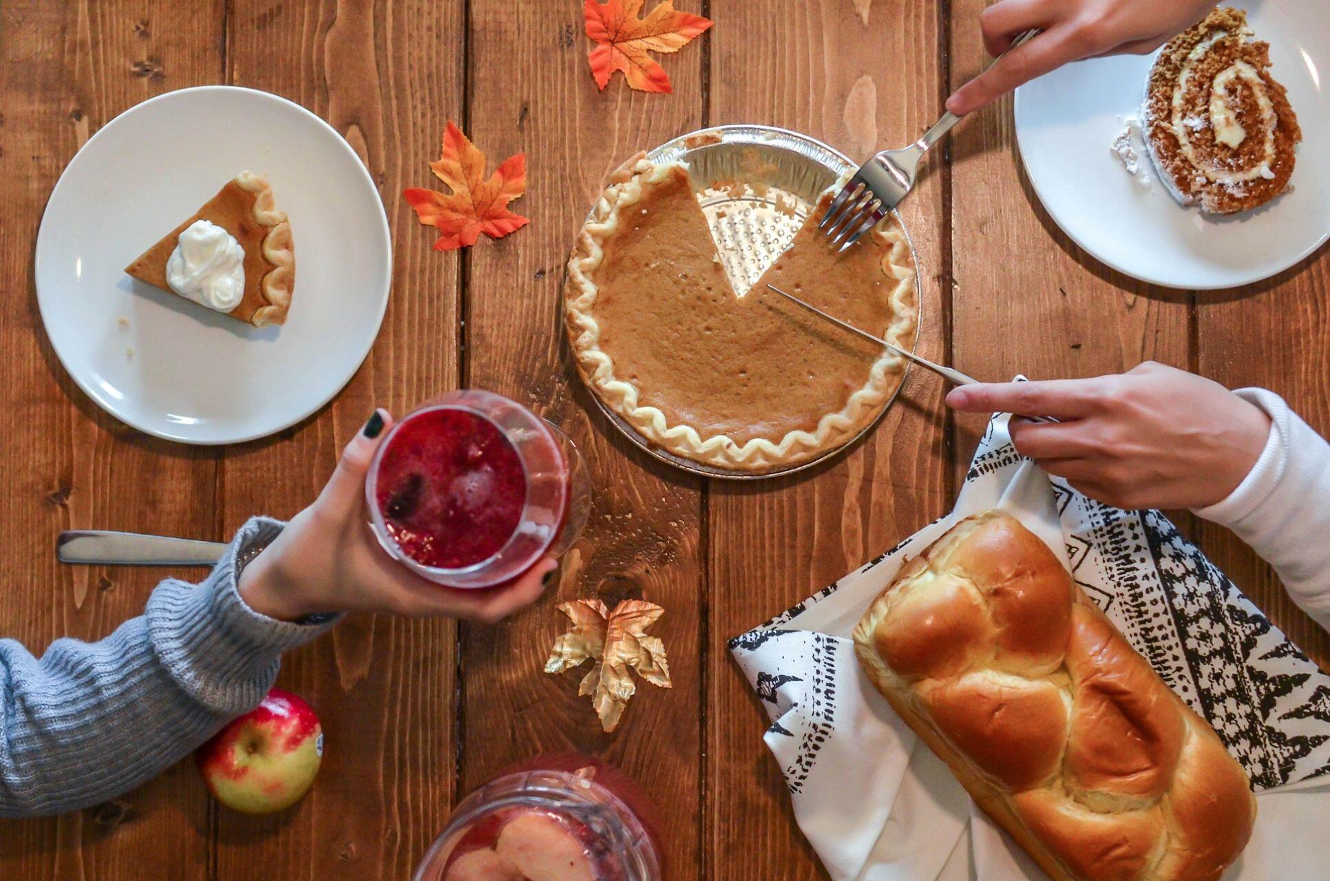 A person cutting pumpkin pie.