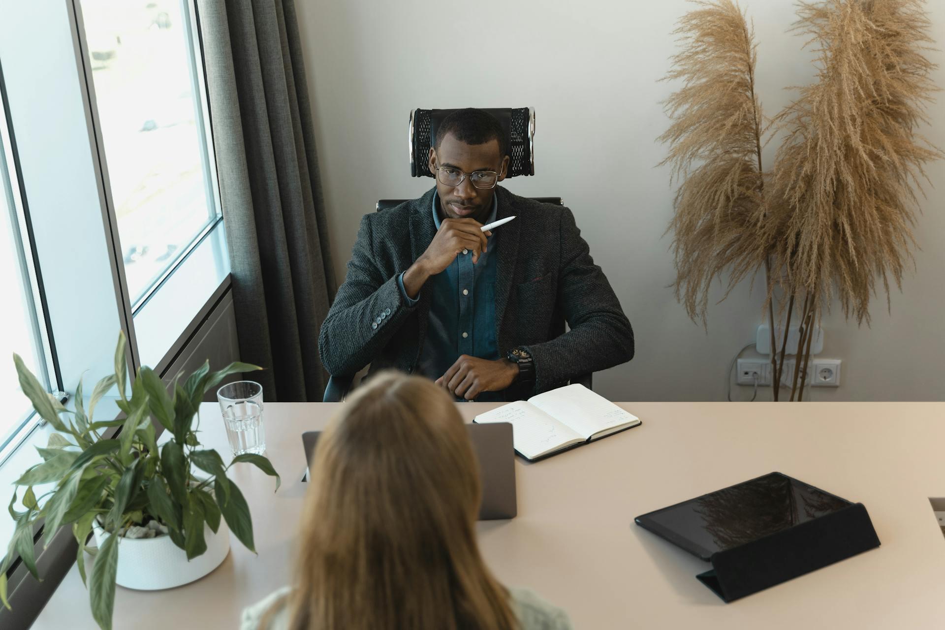 man and woman discussing in an interview setting at an office