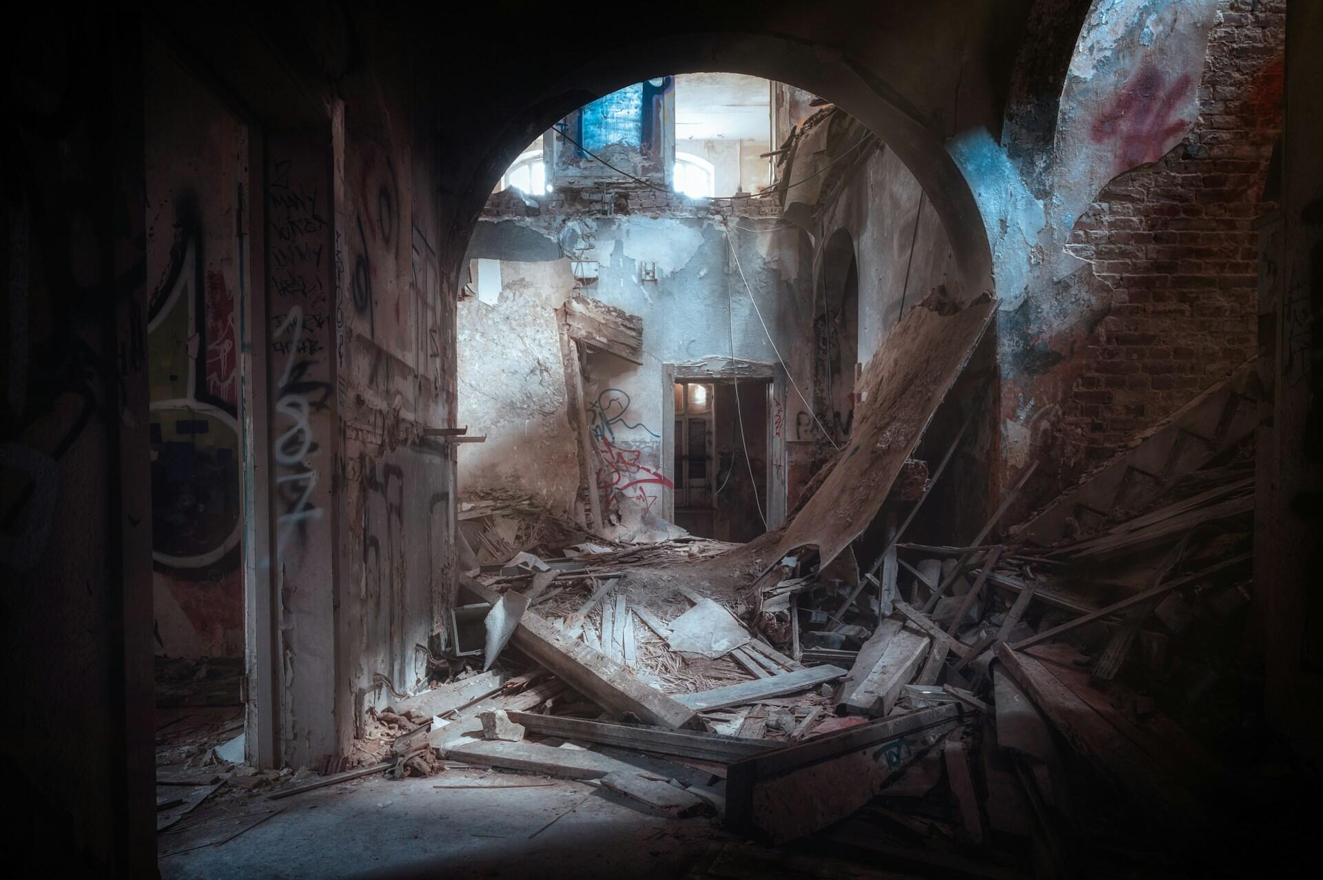 Crumbling buildings and a still-standing archway.