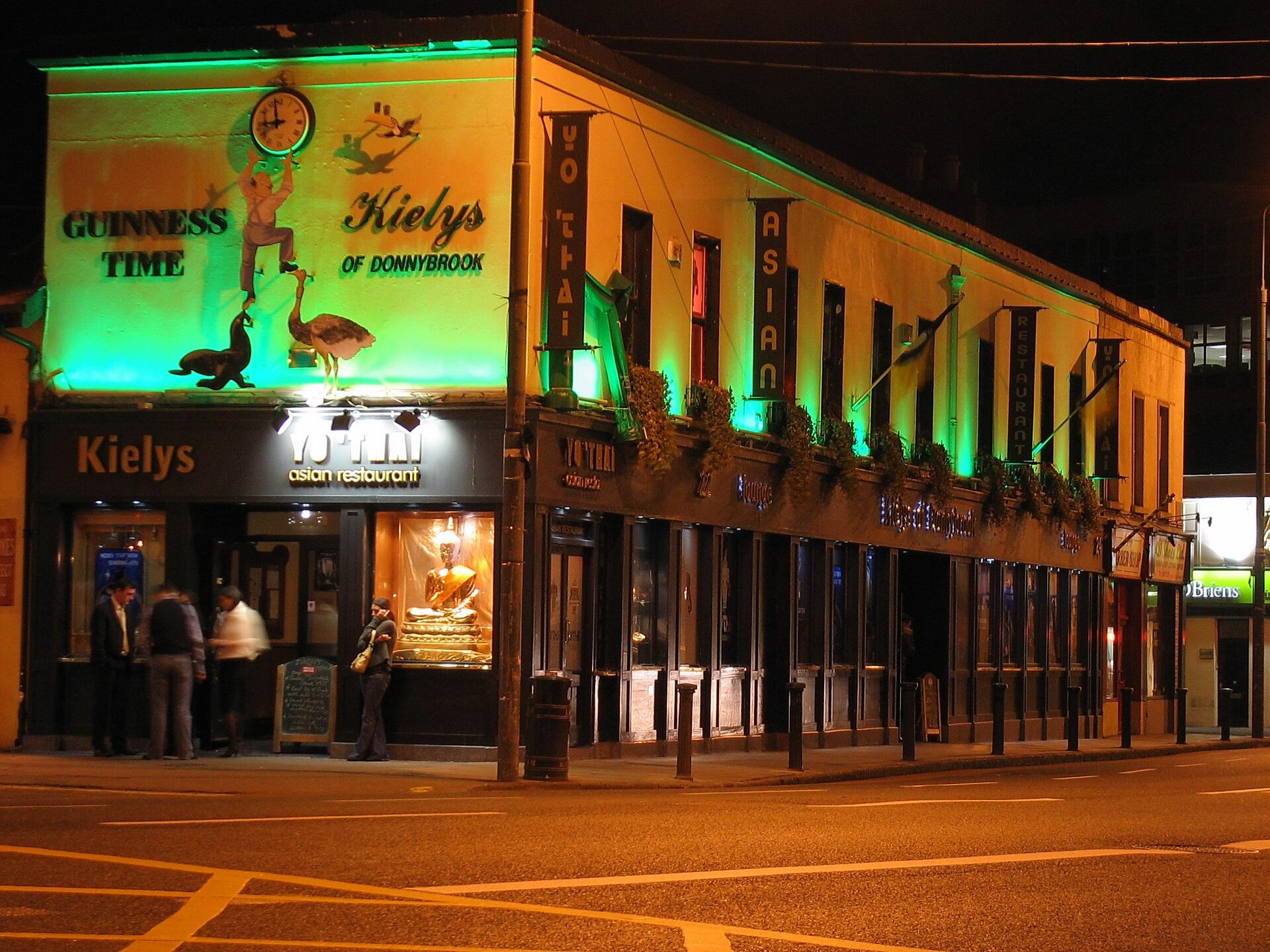A building lit up with green liights at night.