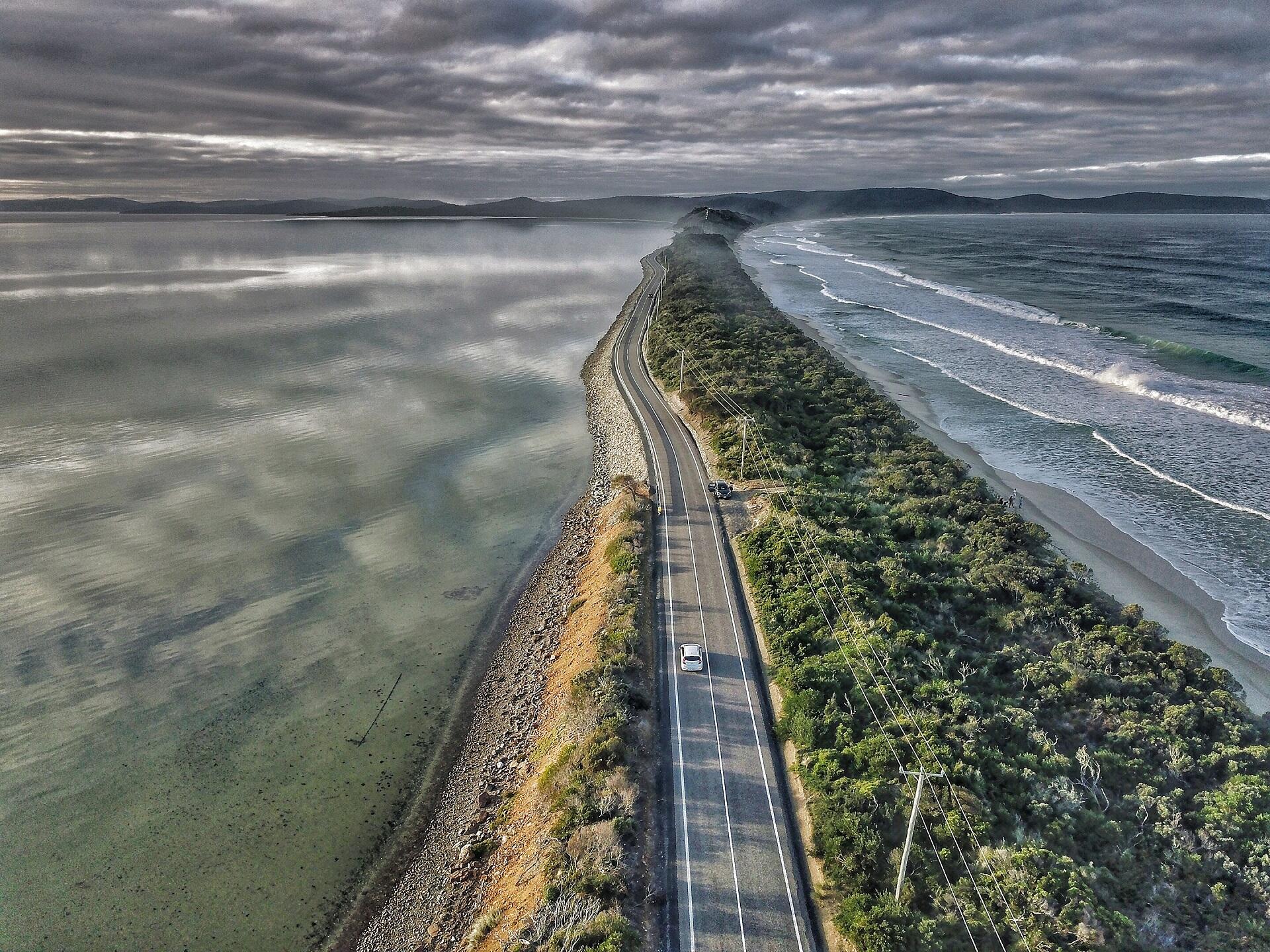 A narrow land bridge surrounded by water.