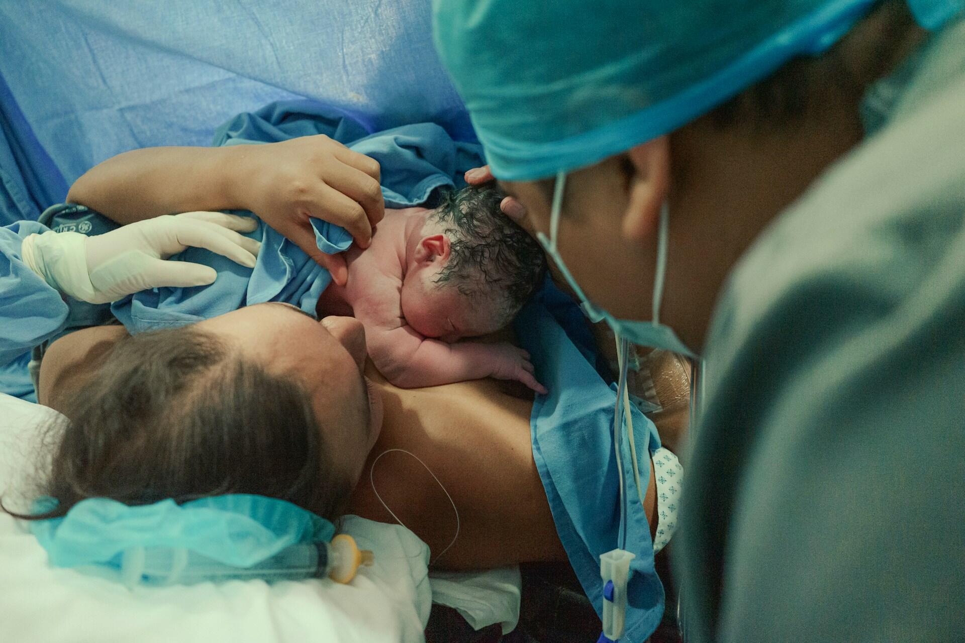 A mother with her baby and a doctor.
