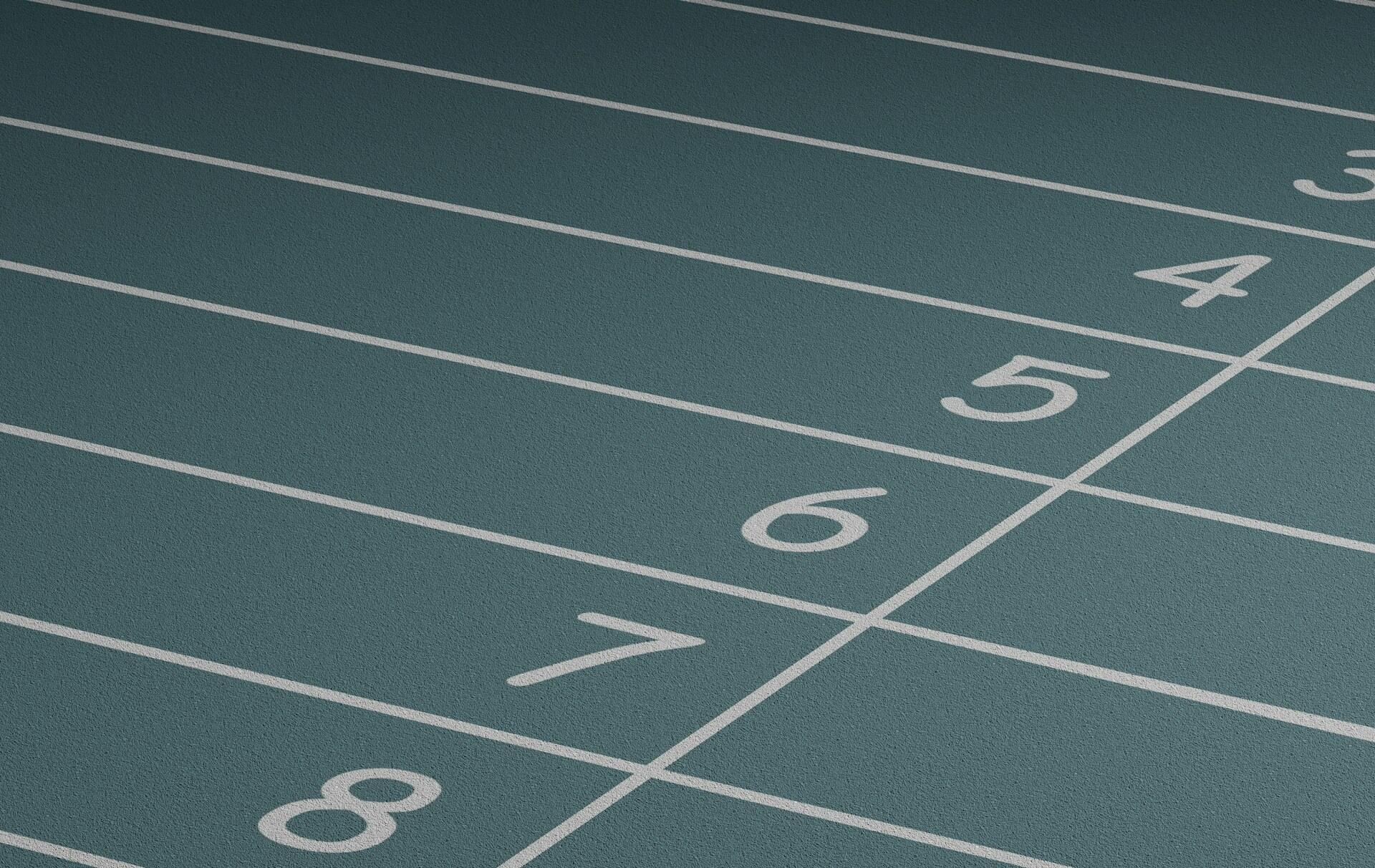 A track number line with numbers in white on a green surface. 