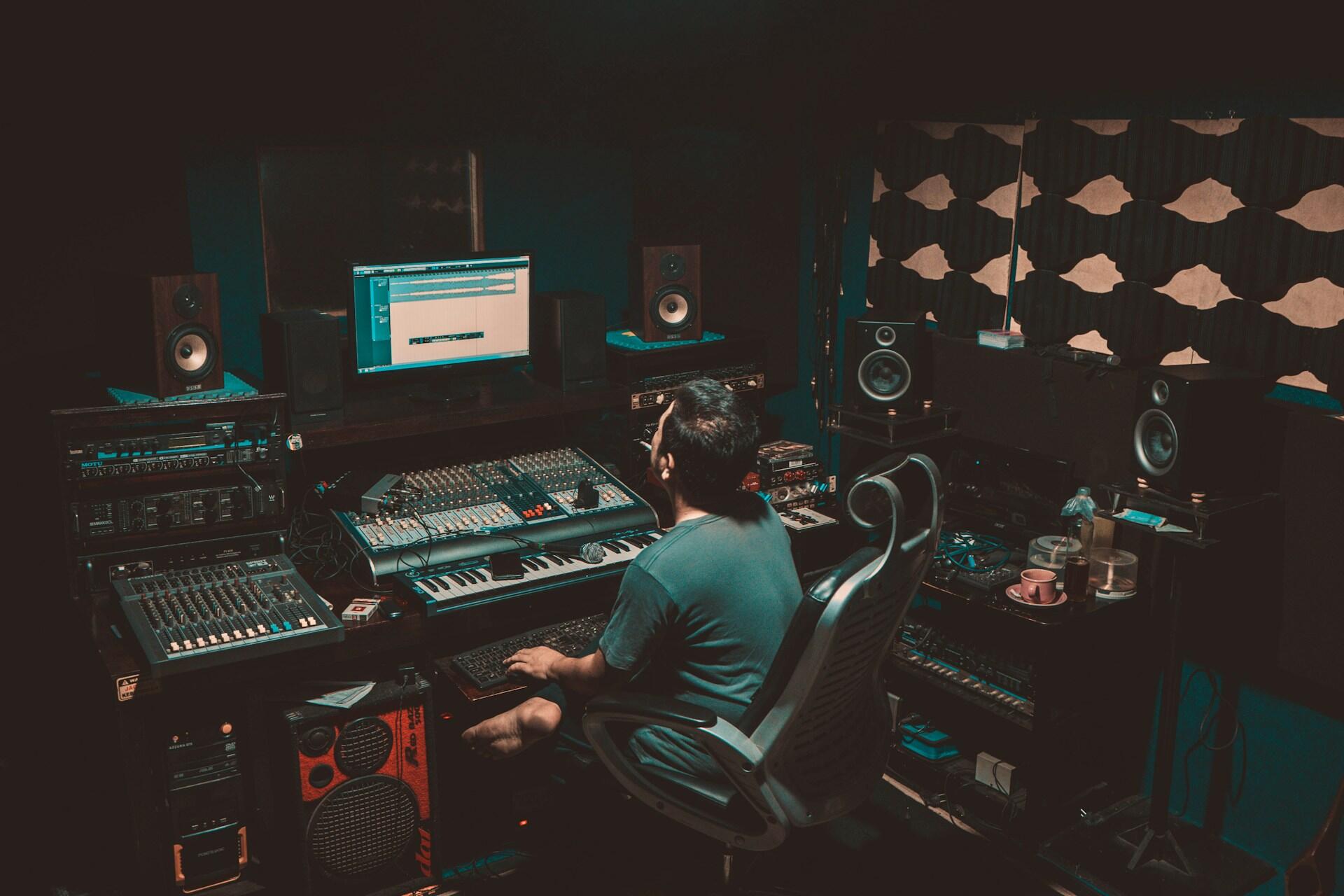 A music producer working in a recording studio.
