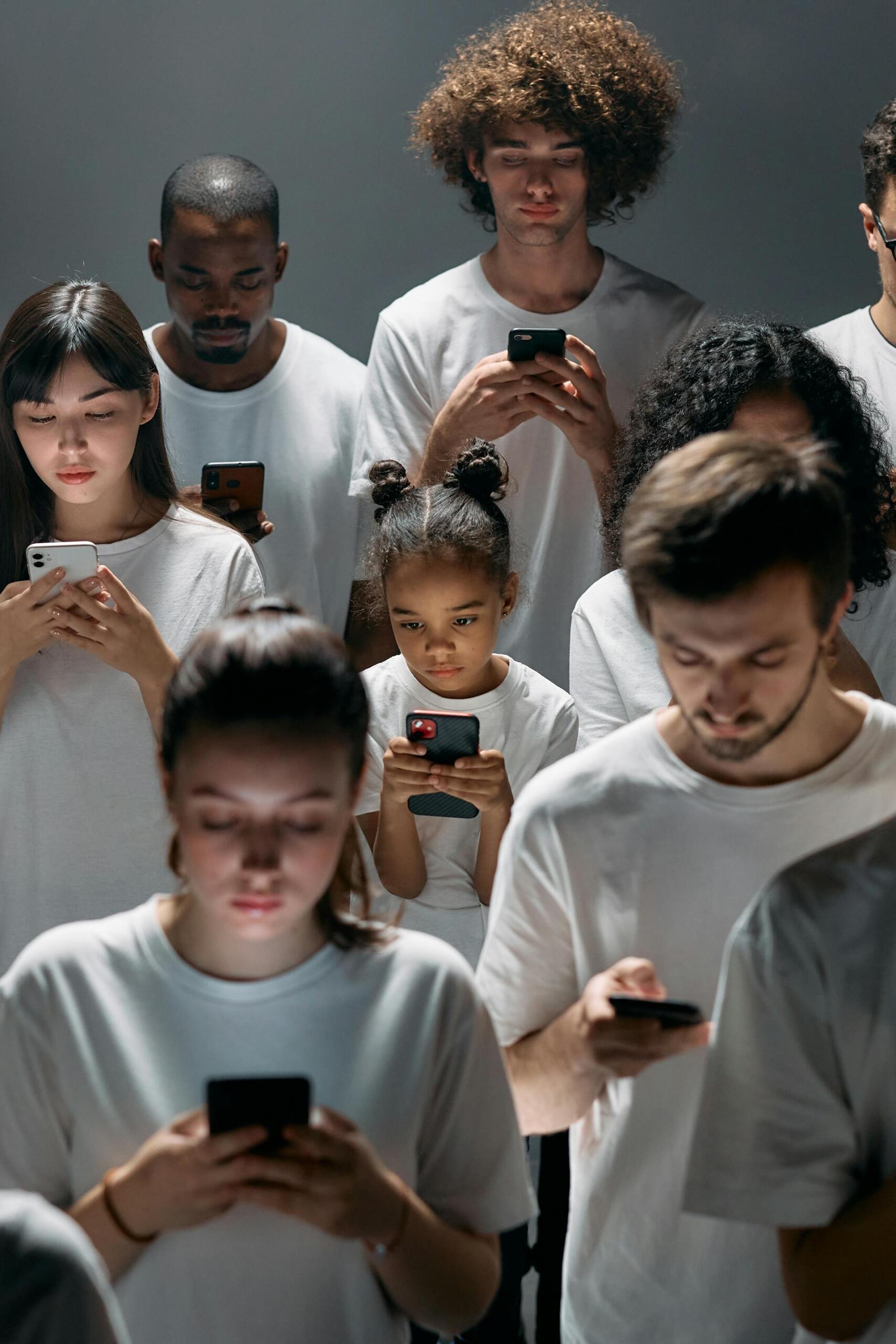 a group of people all looking at their own smart phones