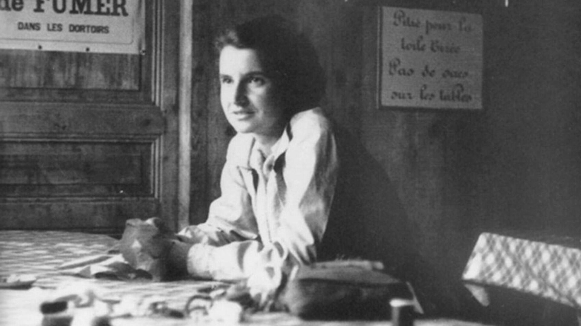 Rosalind Franklin sitting at her desk in Paris.