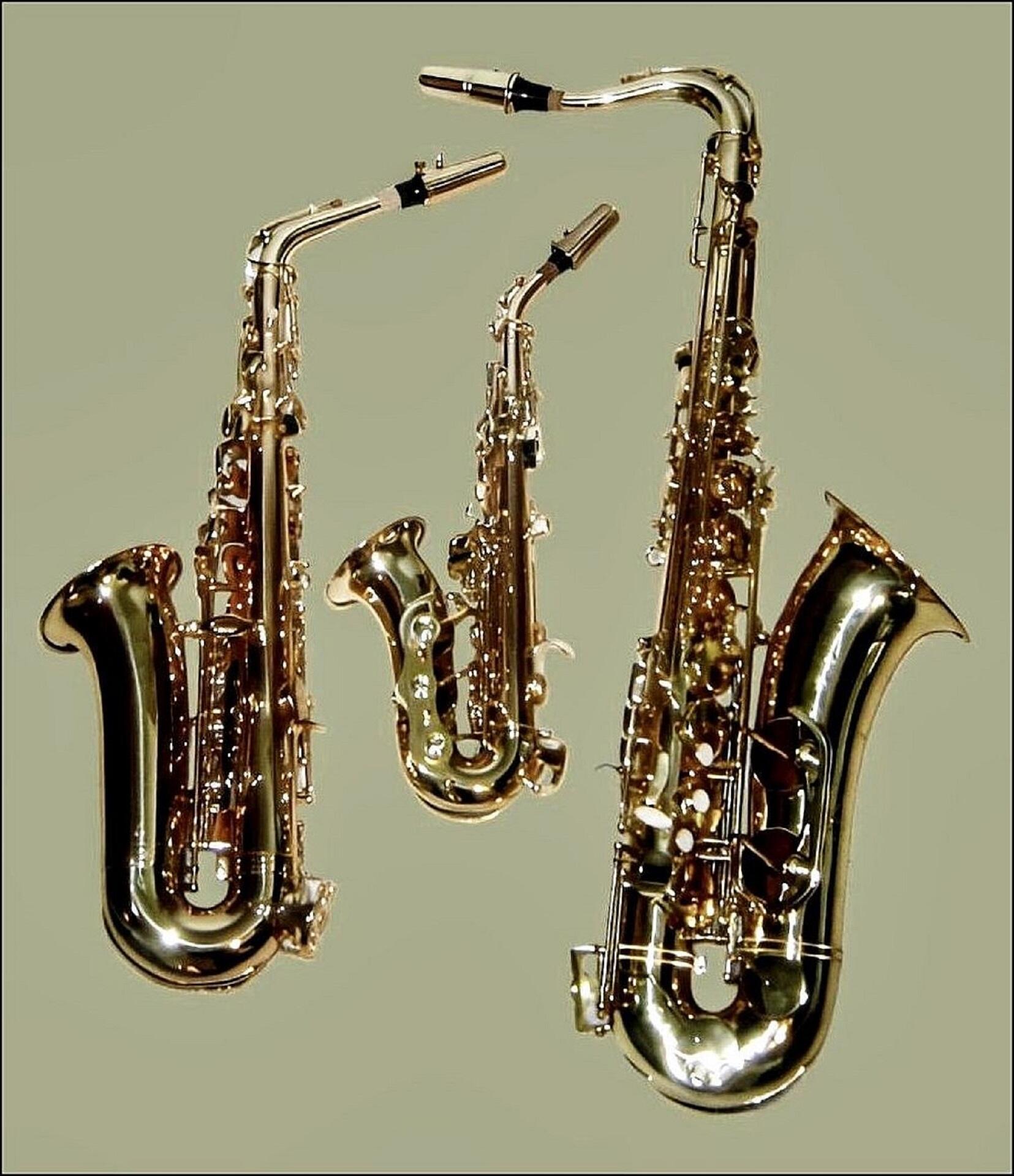 Three saxes of varying sizes side by side. 