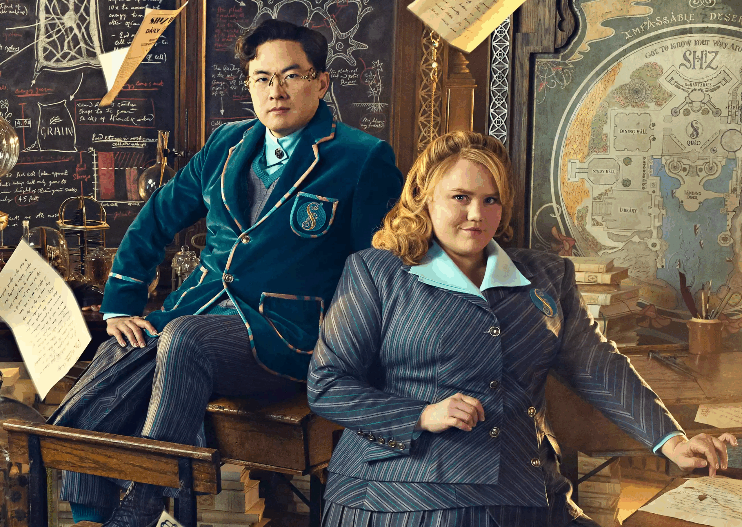 Bowen Yang and Bronwyn James posing for a publicity photo dressed as their characters