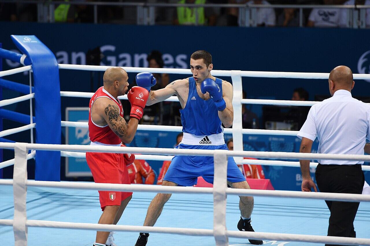 men fighting in a boxing ring