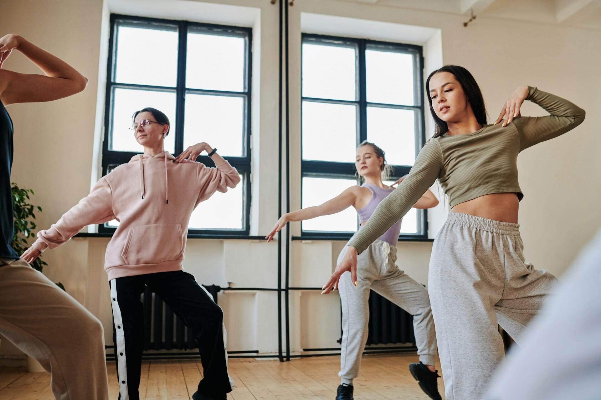 Women dance in a studio.