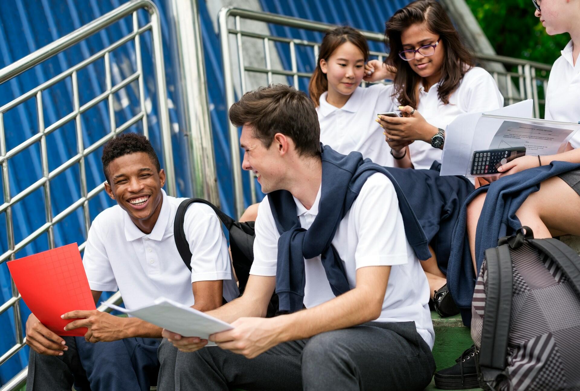 students sitting together dressed in school uniform
