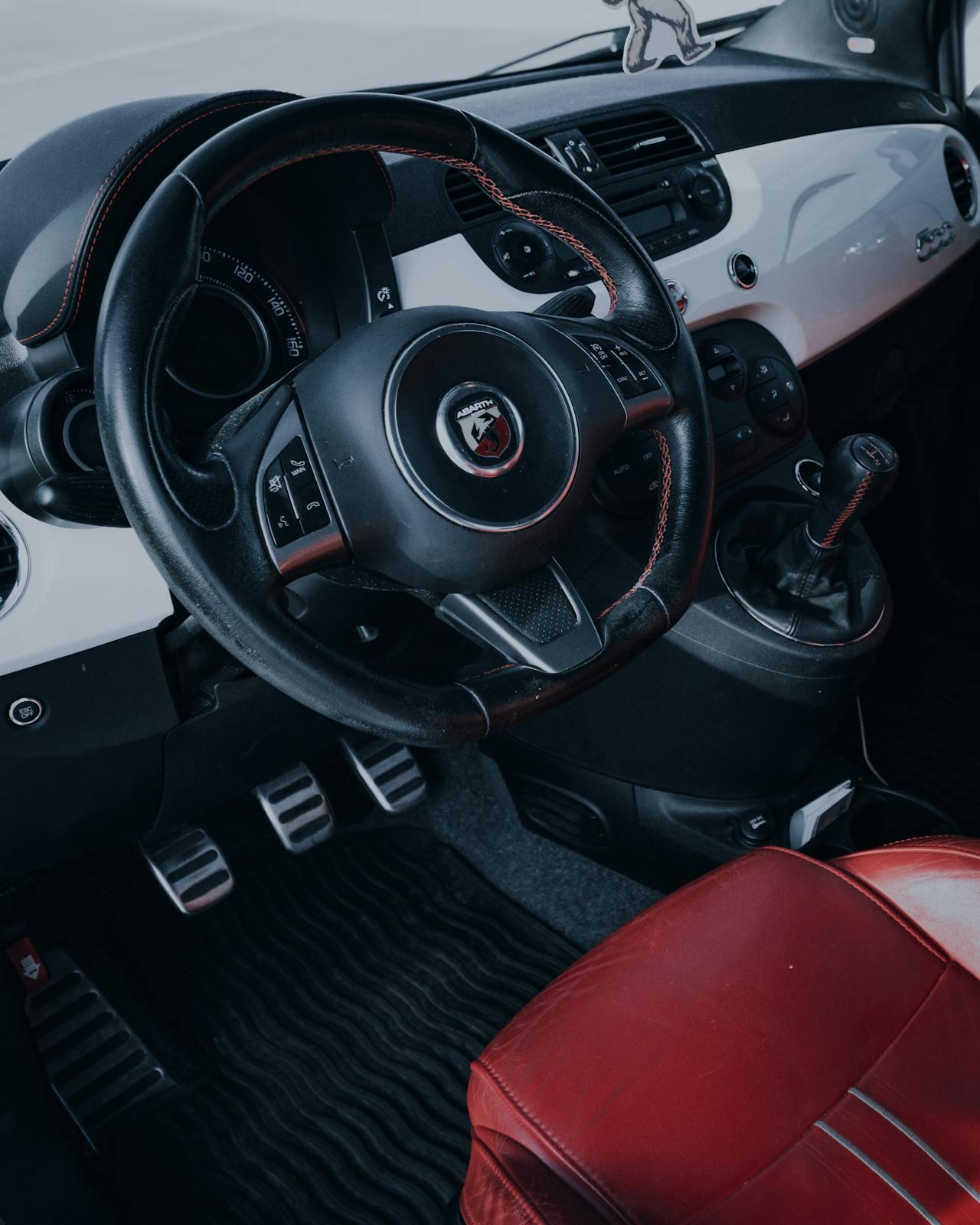 manual car where you can see the 3 pedals and the stick shifter
