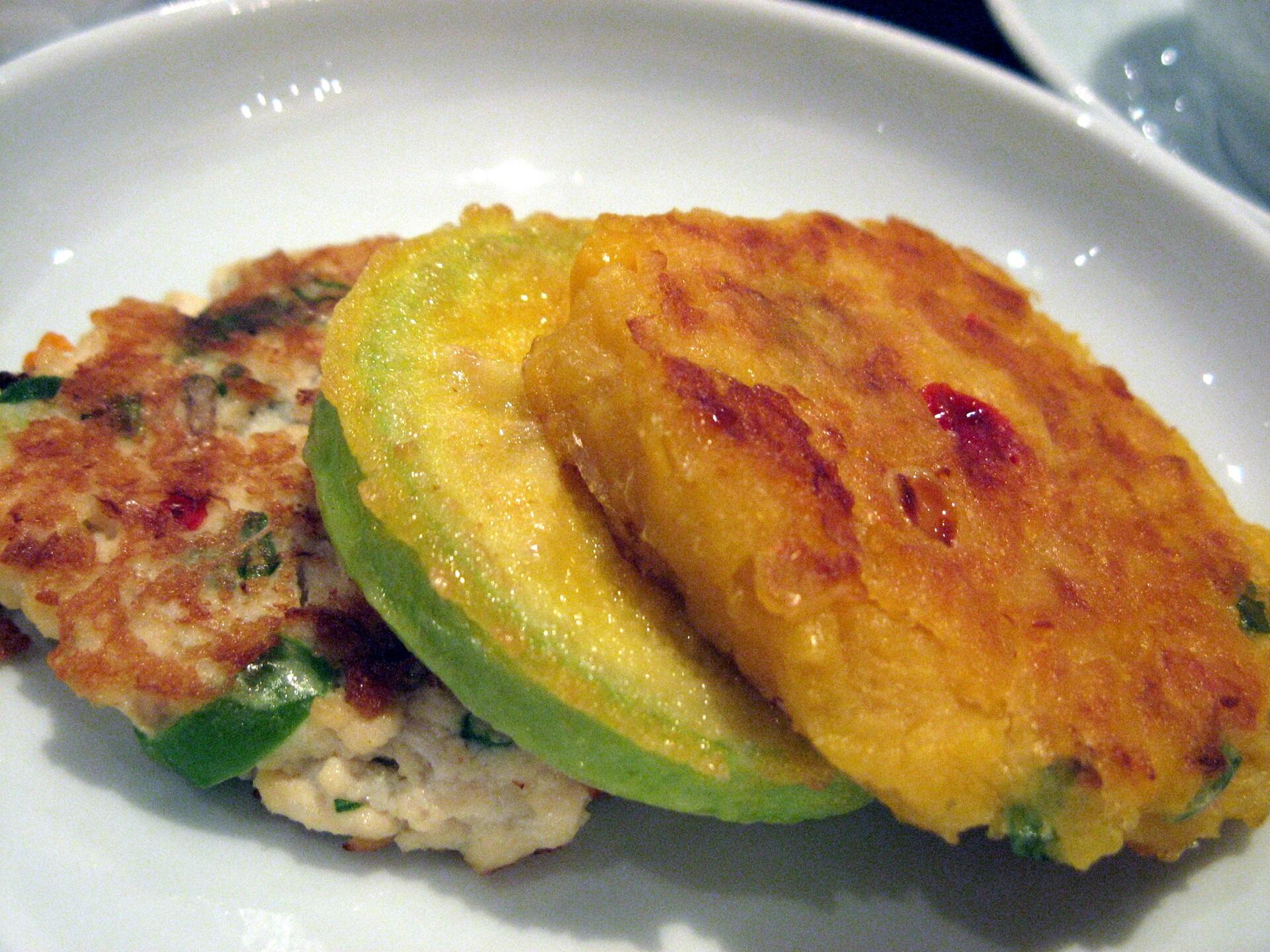 A plate with golden fritters on it. 