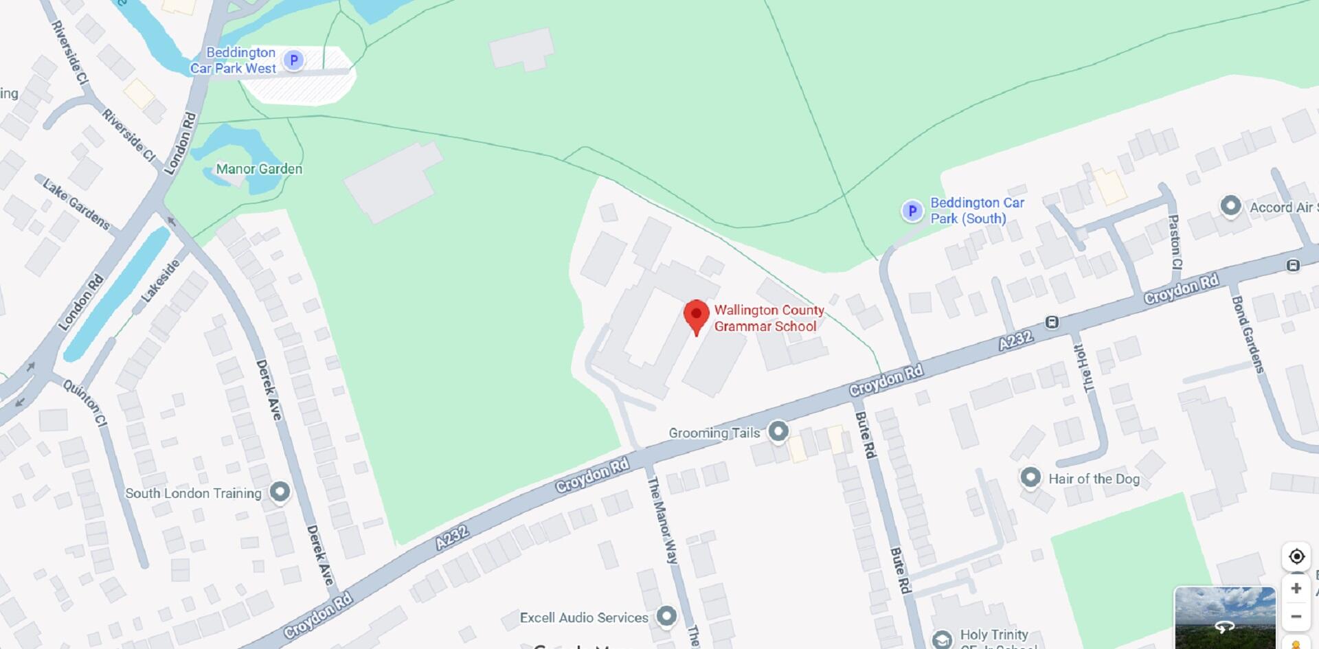 A red pin showing a location next to a large green space on a map.