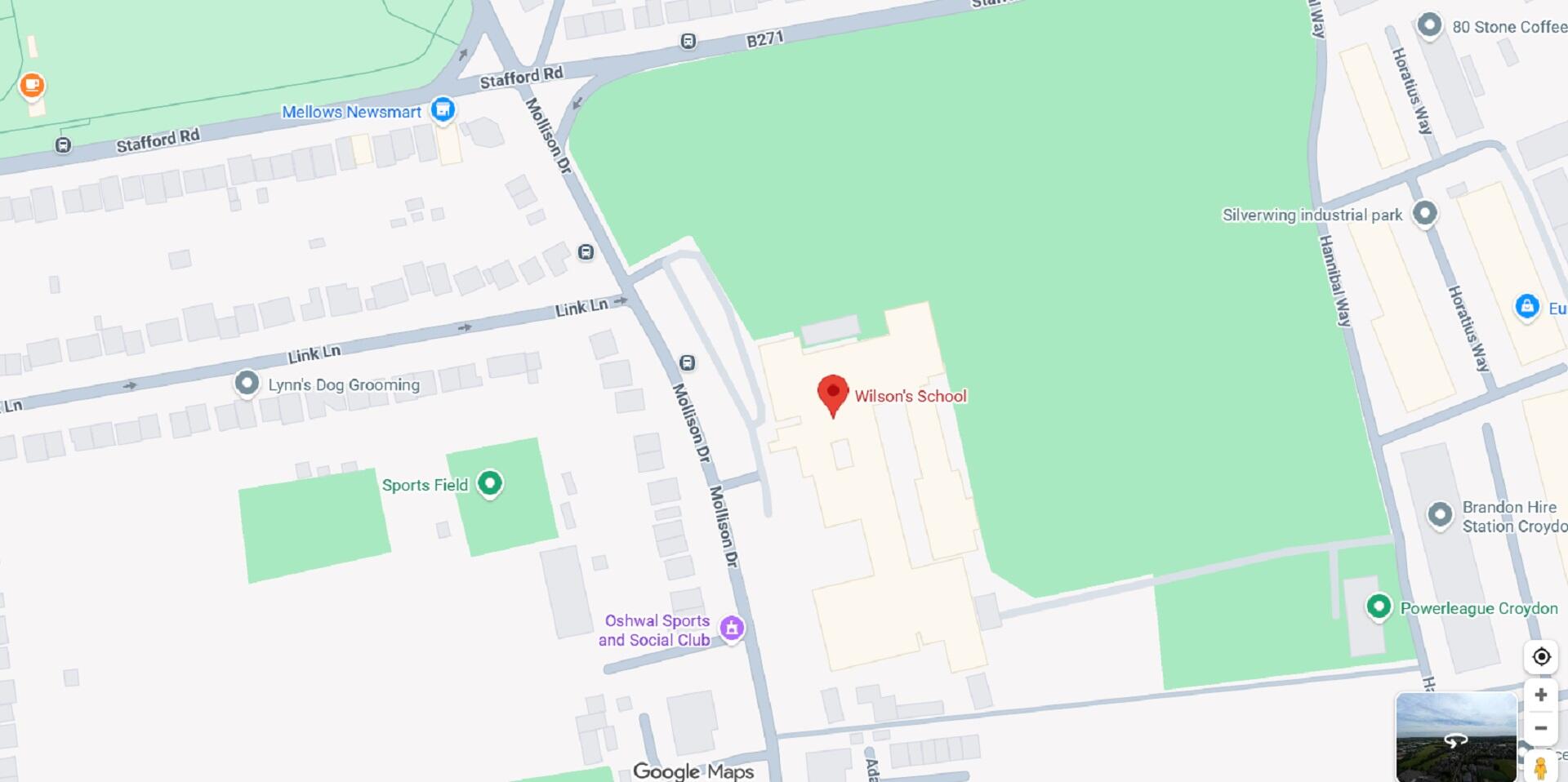 A red locator pin next to a large green space on a map.