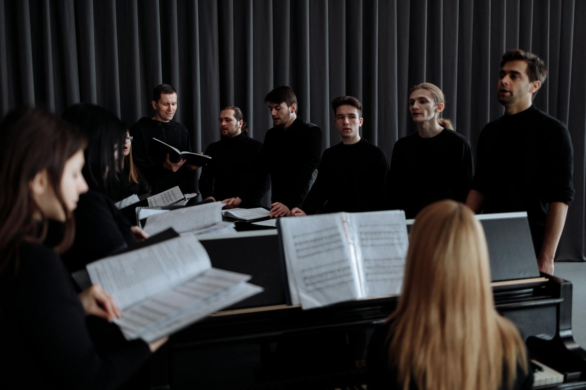 Image of choir singers in a group in a dark environment