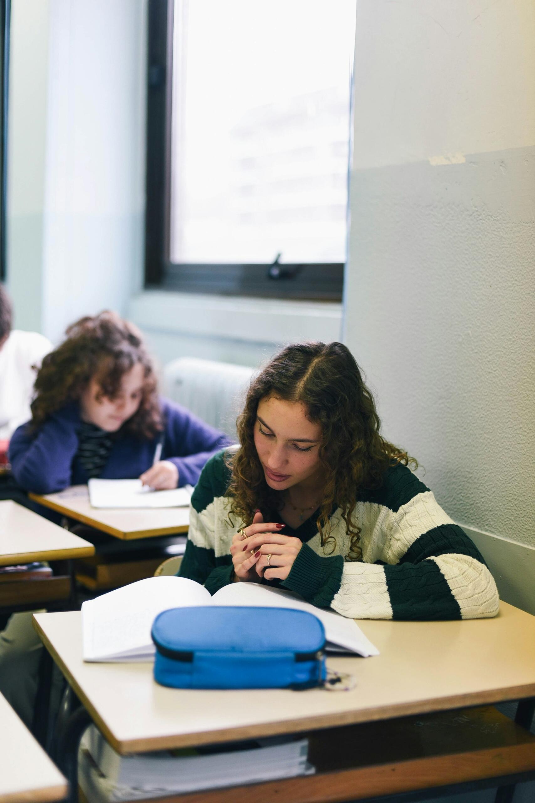 Students in a classroom doing schoolwork. 