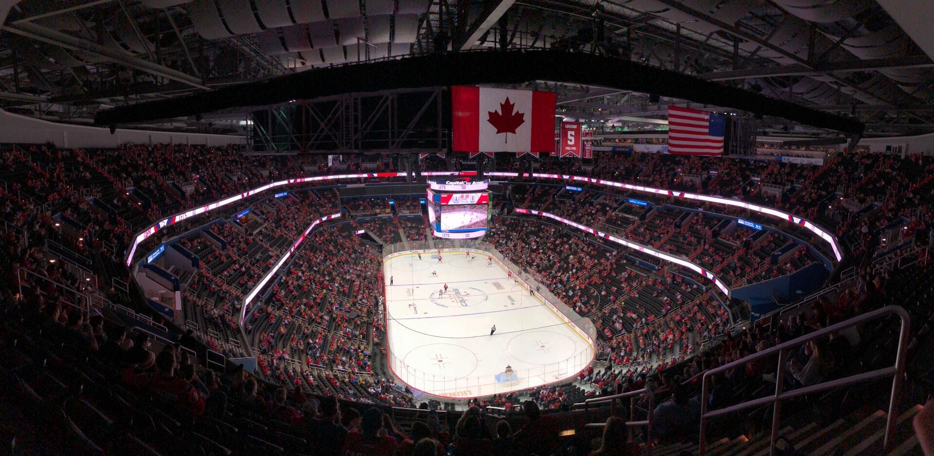 ice hockey rink with canadian flag over top