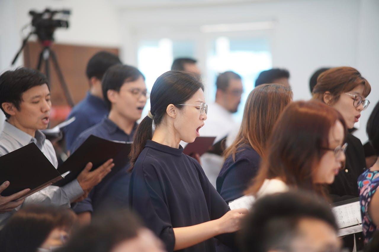 Woman singing in group