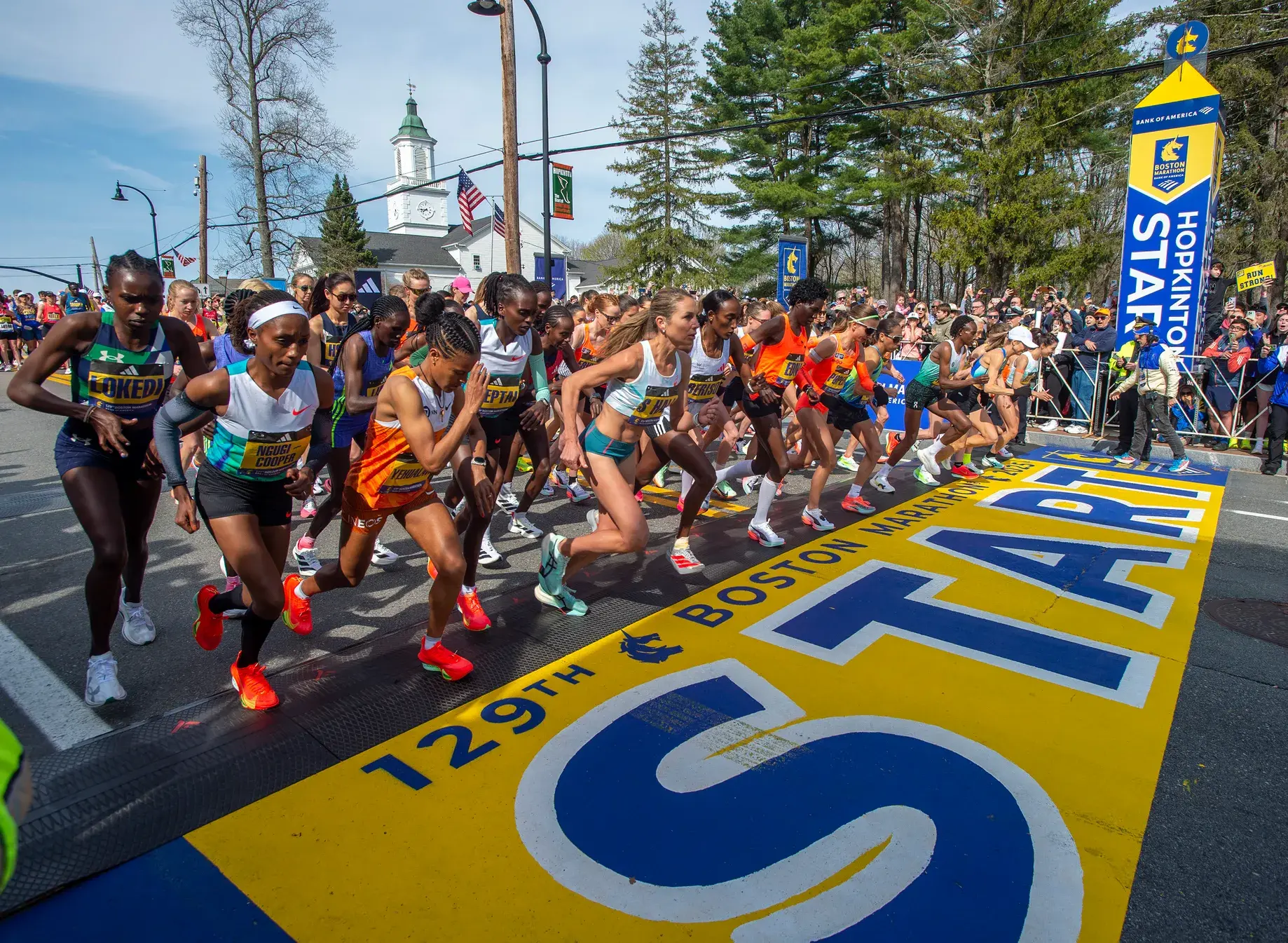 women's elite wave crossing the start line in the Boston marathon