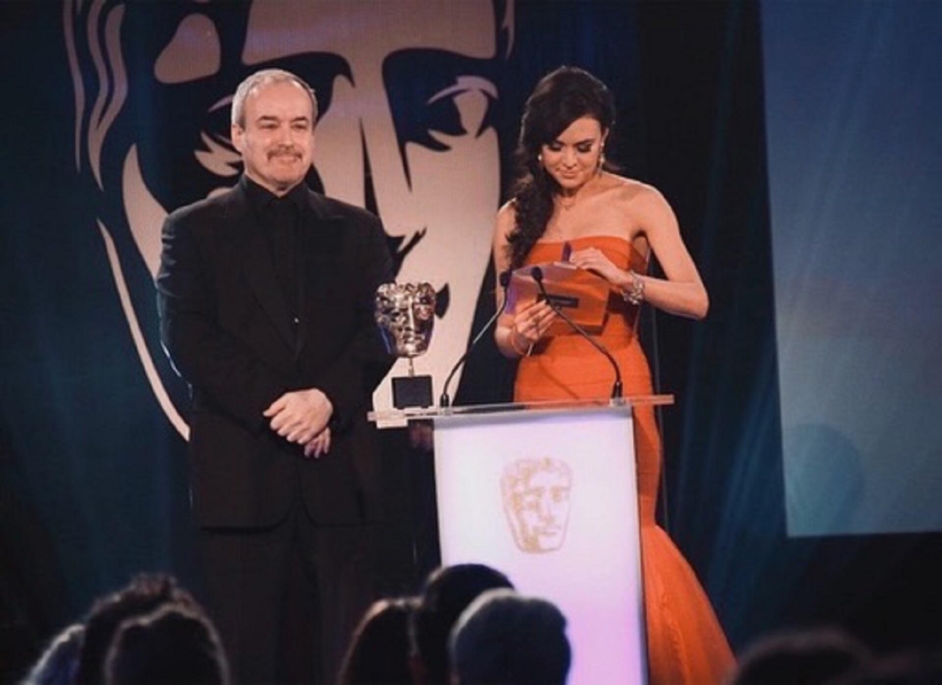 Two people behind a podium presenting an award.